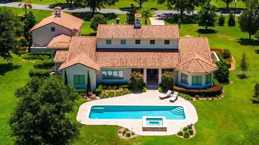 Discover your dream equestrian retreat with this stunning 5.34-acre Tuscan-style estate, located within a beautifully maintained and secure gated community featuring miles of scenic riding trails. Surrounded by an expansive 8,000-acre State Forest, this property offers unmatched privacy and natural beauty—yet remains just 20 minutes from the World Equestrian Center and only 5 minutes from shopping, dining, and medical facilities. Ideally positioned between the Rainbow River and Ocala, it delivers both convenience and tranquility.

The luxurious residence boasts over 3,800 square feet under air, offering 4 bedrooms, 4 bathrooms, plus a versatile fifth room on the second floor. Designed with both elegance and functionality in mind, the home features a dramatic living area with cathedral ceilings, a gas fireplace, and an open custom kitchen complete with high-end finishes, a wine cabinet, and a spacious pantry. A formal dining room, abundant closet space, tray ceilings throughout, travertine flooring inside and out, plaster walls, and precast trim details elevate the home’s refined character. The expansive primary suite provides a private retreat, while the split floor plan ensures comfort and privacy for all.

A breezeway leads to a generous two-car garage with an additional air-conditioned upstairs room—ideal for guests, an office, or hobby space. This award-winning model, recognized by the Builders Association in 2016, blends timeless architecture with modern living.

Outdoor living is equally impressive, featuring a heated 41’ x 14’ pool and spa added in 2020, perfectly positioned to capture breathtaking sunset views. Equestrian amenities include a beautifully constructed 3-stall concrete barn (14x14 stalls) with a tack room, full bathroom, and attached garage (built in 2022), along with two paddocks equipped with automatic waterers, a 200 x 100 arena, and durable creosote board fencing. Ride directly from your backyard onto miles of private trails.

Thoughtfully landscaped with mature and newly planted trees for added shade and privacy, this turnkey property is offered newly furnished, making it truly move-in ready. A rare opportunity to own a luxury equestrian estate where lifestyle, location, and design come together seamlessly.