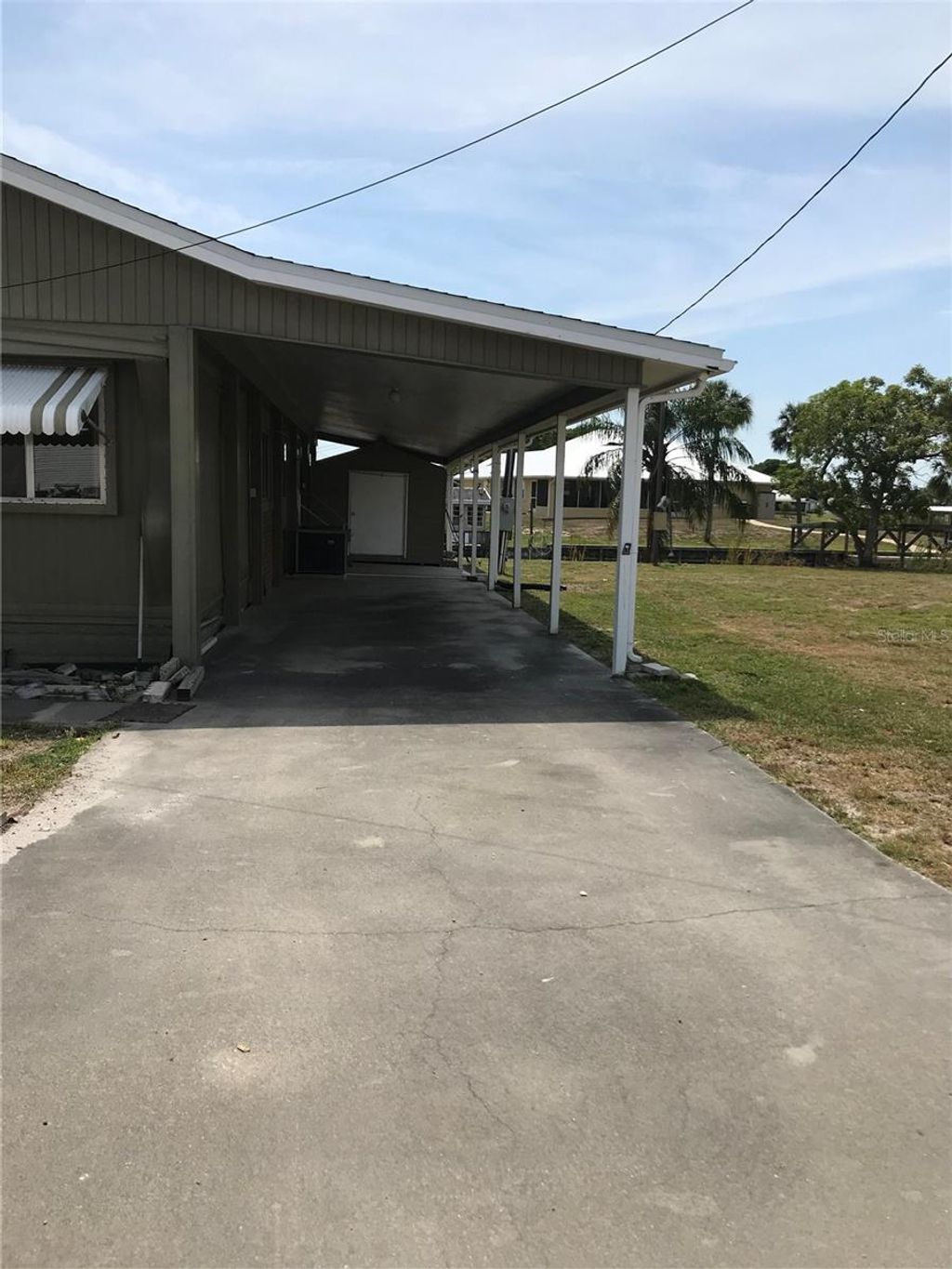 Photo of 1474 Lake Drive W, Okeechobee, FL 34974 (MLS # OK225136)
