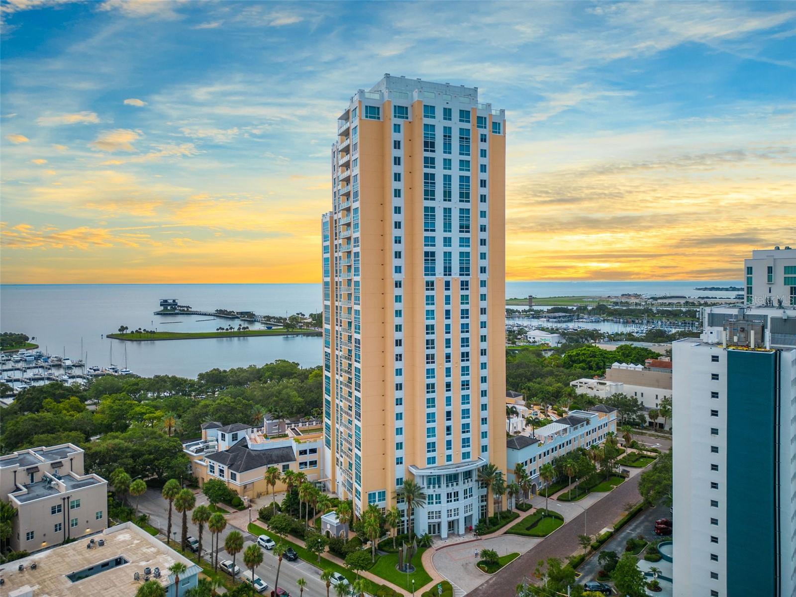 Welcome to 400 Beach Drive! A highly sought-after Luxury high rise in beautiful downtown St Petersburg. This location is amazing because it is walkable to sidewalk cafes and restaurants, coffee shops museums, and waterfront parks. A private secure elevator takes you directly to your unit and opens to your private foyer. Step inside the double doors and you are immediately immersed in the gorgeous water views and views of the Pier, Straub Park, and watch private planes come and go from Albert Whitted airport. This unit offers 3 bedrooms, 3 baths PLUS an office/den. Beautiful Brazilian cherry wood floors throughout with a very spacious open kitchen with breakfast bar. Impact sliding doors lead out to a very spacious balcony where you can sit and watch the sunrise with your morning coffee. The primary suite offers a custom walk-in closet with an en suite bath featuring a garden tub and separate shower and dual vanities. Sliding doors off of the primary lead to another balcony. The guest suite is private and also offers an en suite bath. As a resident, you enjoy all the amenities 400 Beach has to offer! A newly renovated fitness center with state-of-the-art equipment, and a pool area that offers a hot tub and a grilling area. Feel free to lounge in the beautiful social room, perfect for gatherings or private parties or business meetings. There are 2 parking spaces in the private parking garage and a temperature-controlled storage room. 400 Beach is a private, secure building with on-site management and 24-hour concierge service that provides security and attention to all of the resident's needs with great detail. Come live the life of ultimate luxury in our beautiful downtown St Petersburg!