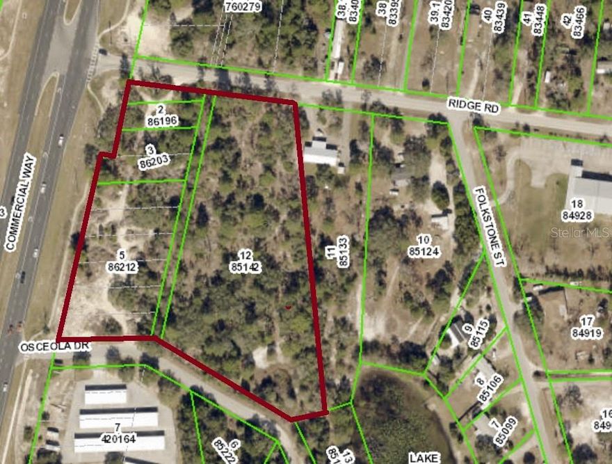 Rare opportunity to a large parcel of land with estimated 510-feet of frontage on Commercial Way / US-19 with rapidly growing traffic count now estimated at over 25,000 vehicle per day. Property borders two side roads for easy development access. Now zoned R-1A residential but location should allow commercial rezoning. Current zoning could make land ideal for multi-family, town-homes, assisted living or nursing facility, medical offices, church or commercial development. Connection to county sewer and water possible.