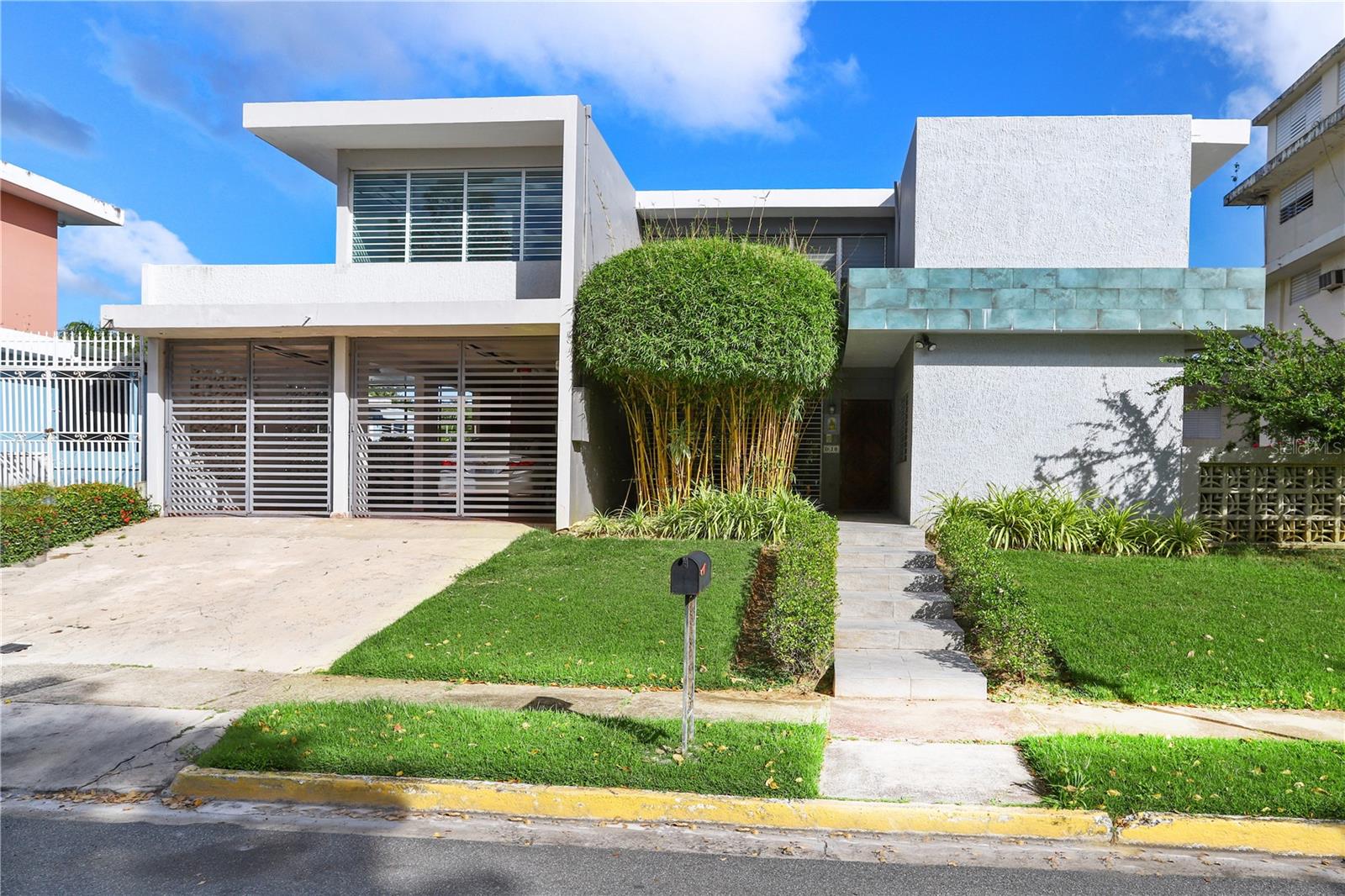 Stunning property in Extension Villa Caparra, located on Calle Roma D10. This two-story custom-built 2834 sq ft, boasting a tropical open space. With five spacious bedrooms, four and a half bathrooms; three of those bedrooms with "in-suite"bathrooms. A sprawling 817 sq mts flat patio with a big mango tree; there's ample space for your family to thrive and build a pool and terrace. Back of the property is adjacent to Fort Buchanan and the front is overlooking the neighborhood park. This home provides 24-hour security and easy access to San Patricio Plaza, renowned restaurants, and boutique shoos. Equipped with modern amenities like Kenmore appliances, four mini-split A/C units, a generator with a transfer switch, and a water tank, this property ensures comfort and convenience. Its proximity to excellent schools, effortless commute via expressways and major roads, and a remarkably low HOA fee of $75 make it an ideal choice, actual annual property tax $960. Don't miss out on this incredible opportunity to make it your forever home.