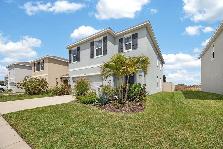 Welcome to one of the most desirable and largest 5-bedroom homes in the highly sought-after Southshore Bay lagoon community in Wimauma, located within the rapidly growing Tampa Bay region. This exceptional residence offers a rare opportunity to experience true resort-style Florida living with direct, unobstructed panoramic views of a stunning 5-acre crystal-clear lagoon, all within a short walk from your front door. Ideal for buyers seeking a luxury home with water views, relocation to Florida, or a high-demand lifestyle community. Built just two years ago with durable concrete block construction on both floors, this home provides superior structural integrity, energy efficiency, and long-term durability. Designed to withstand Florida’s climate, the property offers peace of mind and modern construction standards that today’s buyers prioritize. Situated within a gated community featuring elegant fountains and beautifully maintained surroundings, the property blends luxury, security, and lifestyle. The outdoor living space is a standout feature, boasting an expansive 750-square-foot covered lanai designed for entertaining and relaxation. Enhanced with LED ambient lighting, ceiling fans, and premium artificial turf, this space is ideal for hosting gatherings or creating a private retreat. The fully fenced backyard ensures privacy and functionality. Inside, the home offers a spacious and thoughtfully designed layout with five bedrooms, including a first-floor bedroom with an adjacent ADA-compliant bathroom featuring a walk-in shower and accessibility features—perfect for multigenerational living or guests. The primary suite provides a spa-like experience with an 8-jet whirlpool tub, oversized walk-in closet, and upgraded finishes throughout. The kitchen is equipped with modern upgrades including a designer range hood ventilation system and custom wall panel accents. Additional enhancements include premium ceiling fans in all rooms and a whole-house Rheem water softener system. Energy efficiency and long-term savings are a major highlight. The home features a fully owned (not leased) high-performance rooftop solar panel system with a 30-year transferable warranty, generating approximately 16,100 kWh annually. This significantly reduces or nearly eliminates electricity costs while offering long-term savings and increased home value. Excess energy production may provide utility credits, making this an ideal energy-efficient home. A Level-2 electric vehicle charger is also installed in the garage. Community amenities further elevate the lifestyle, with HOA dues including high-speed UltraFi internet (500 Mbps) and a comprehensive cable package. The lagoon community offers a unique Florida resort-style living experience with beach-style recreation, water activities, and a vibrant social environment. Additional features include a fully automated irrigation system, professionally maintained landscaping, and mature palm trees enhancing curb appeal. This property represents a rare combination of location, energy efficiency, luxury upgrades, lagoon views, and resort-style amenities, making it one of the most compelling homes available in the Southshore Bay community and the greater Tampa Bay real estate market. Smart home features, open-concept living, and abundant natural light enhance everyday comfort. Convenient access to shopping, dining, beaches, and major highways makes this an ideal primary residence, second home, or investment opportunity.