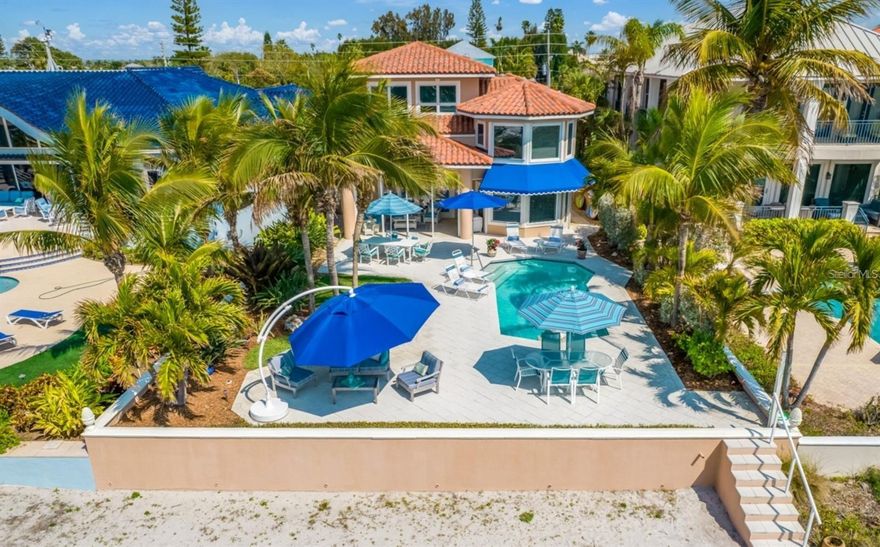 This solidly constructed Gulf Front residence is ideally situated on exclusive Redington Beach. It sits perched on a generously deep beachfront lot with natural sand dunes. This combination provides uncommon protection and privacy. Initially constructed in 1998, it was upgraded and expanded in 2015. The open concept first floor provides sparkling views of the Gulf of Mexico from the moment you enter. Custom estate moldings harmonize with the light hardwood flooring and the soothing wall palate to set a tone of warmth and comfort. The expansive living room with its high ceiling and natural gas fireplace provides a comfortable environment for large gatherings. Ample seating for family and friends is provided at the spacious curved kitchen island and in the adjoining informal dining area. Kitchen features include extensive solid wood cabinetry with slide outs, Cambria quartz countertops, Subzero refrigerator/freezer, dual Wolf convection ovens, Wolf natural gas cooktop, wet bar with U-Line wine refrigerator. The elegant formal dining room provides an intimate space for more elaborate gatherings. There is also a den or office with built-in cabinetry. The second level features the comfortable master suite with angled picture windows that afford stunning panoramic views. Two king sized guest bedroom suites and the laundry room complete this level. Located on the top level is a comfortable family room with sweeping Gulf views and two additional generously proportioned guest bedrooms with adjoining baths. A 3-stop elevator provides added convenience. An extended height two-car garage contains a storage loft, two storage closets plus an air-conditioned workshop/storage room. Exceptional outdoor entertaining options abound while enjoying the mesmerizing views and soothing breezes in this tranquil paradise. Spend time relaxing on the sugary sand beach or floating in the heated pool equipped with swim and spa jets. Relax under the coconut trees on the Shellock paver patio or under the covered lanai enjoying the amazing sunsets. Built to exceptional quality standards: concrete block construction, foundation pilings, pre-stressed concrete floors (levels 1&2), Anderson windows and patio doors, impact glass or hurricane shutter protection on all Gulf facing windows and doors as well as the entire 3rd level, a built-up asphalt roof under a 50-year clay tile roof. Opportunities like this are rare! Schedule you private showing today.