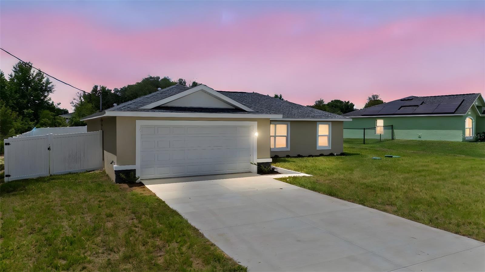 This home is fully fenced!!! I'm excited to share details about a brand new 4-bedroom home in Citrus Springs the Banyan model! This home features an open-concept, split floor plan with a modern design. You'll love the high ceilings and abundant windows that create a bright and inviting atmosphere throughout. This home is also fully fenced. The impressive kitchen is a highlight, offering a large island perfect for meal prep or casual dining. It boasts soft-close cabinets for generous storage, gleaming granite countertops, and stainless steel appliances for a touch of elegance. An undermount sink and recessed lighting complete this functional and stylish space. The primary bedroom is designed as a comfortable retreat, featuring a tray ceiling, a spacious walk-in closet, and an en-suite bathroom with granite countertops and beautiful wall tiles. For your comfort and convenience, easy-care LVP flooring flows through the living areas and bedrooms, with tile in the bathrooms and laundry room. Additional features include a covered entryway, a conveniently located laundry room, modern light fixtures, and a garage door opener. This is a fantastic opportunity, and I encourage you to schedule a showing today to see if this could be your forever home! The property is fully fenced, offering privacy and security.