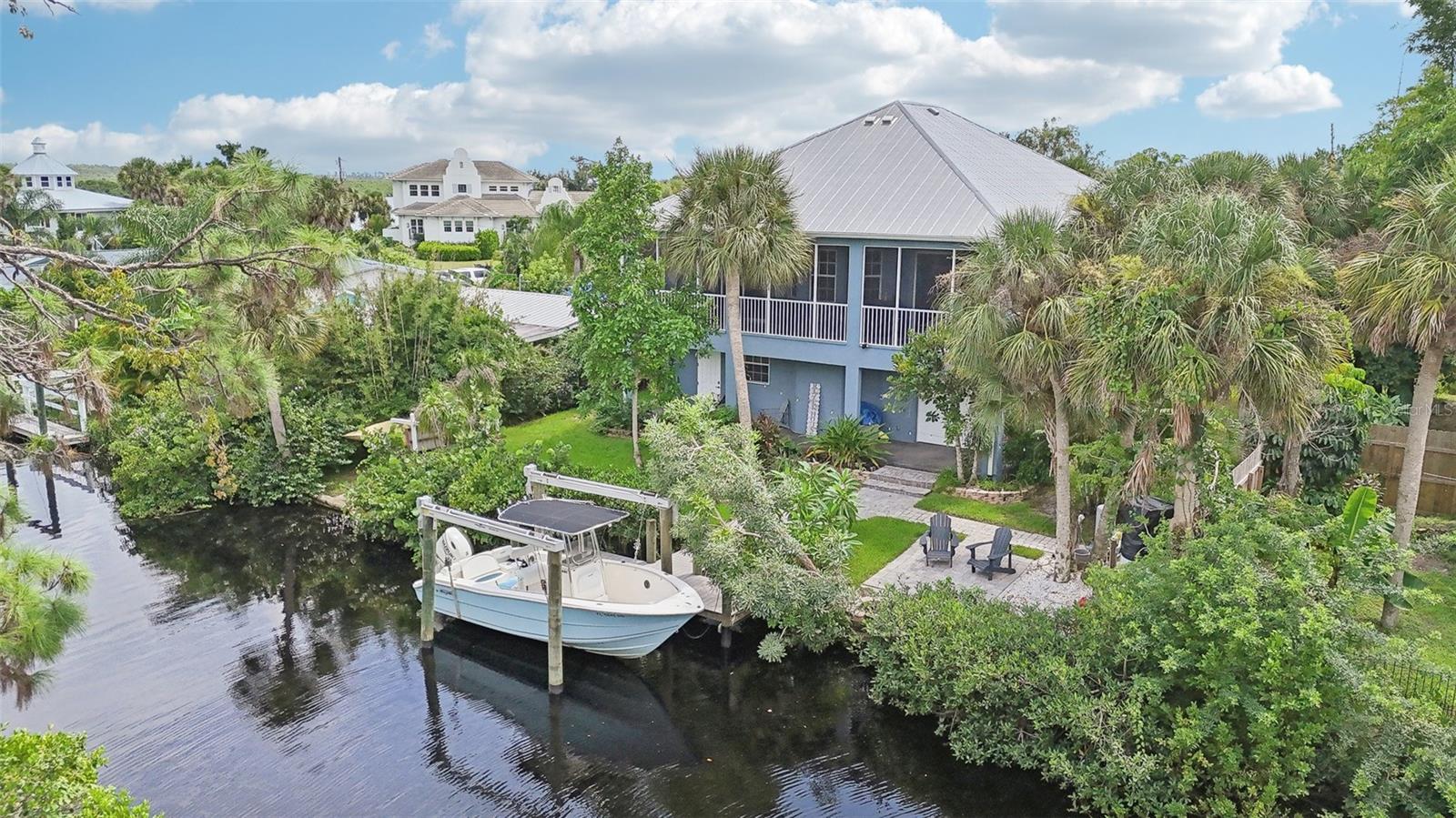 Welcome to this remarkable, WATERFRONT property (with A TRANSFERRABLE FLOOD POLICY THAT IS ONLY 966.00 PER YEAR), that offers a plethora of features and updates to excite boating enthusiasts as well as a 4+ CAR GARAGE to store all of your vehicles and water toys. Enjoy the feel of OLD FLORIDA with NO HOA or CDD to drain your pocketbook.
This meticulously maintained home is a unique, two level, custom build with solid features such as FULL BLOCK CONSTRUCTION, METAL ROOF, and recently rebuilt staircase/entry landing. The property also boasts mature, lush landscaping for beauty and privacy. Most of the living area is located on the second level, which is easily accessible with the home ELEVATOR. The front door landing is spacious and provides a beautiful introduction to the home. When you step inside, you will be wowed by the airy, modern feel of the home with features such as high ceilings, large pocket sliders and GRANITE countertops. Two of the 3 bedrooms have en-suite bathrooms, and the large master suite boasts extras such as soaking tub, CUSTOM HIS AND HERS CLOSETS, and balcony access. The lengthy SCREENED-IN BALCONY overlooks the canal and gives a great partial view of the Myakka River. The home is also equipped with a full house REVERSE OSMOSIS system, which provides tasty, pure water right out of the tap.
Boaters will be delighted by the newer DOCK and 10,000 lb BOAT LIFT, allowing for seamless access to the tranquil MYAKKA RIVER. Imagine enjoying A beautiful sunrise from the comfort of your 2nd floor, screened in lanai or taking leisurely boat rides and exploring the coastal scenery just minutes from your doorstep. The property's location offers the convenience of a 10 minute boat ride to the nearest waterfront restaurant, 15-minute ride to the El Jobean Bridge and a 40-minute ride to downtown Punta Gorda and 50 minutes to Boca Grande and the Gulf, providing endless opportunities for entertainment and exploration.
The property is situated on a cul-de-sac in a well established, yet intimate waterfront neighborhood of custom homes The entire neighborhood is at the end of a lesser-traveled singular road, providing a degree of quiet and privacy that is a rarity. Access to Downtown Wellen Park and its many restaurants, shops, entertainment and other amenities will be in very close proximity (once the present development is completed), making this location the perfect combination of seclusion and convenience.