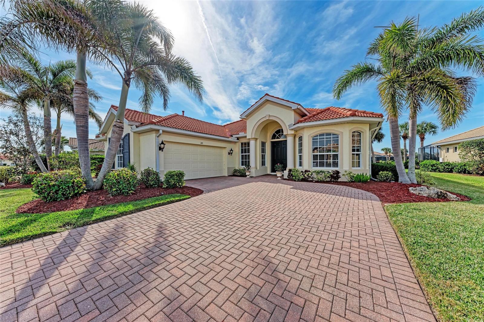 Welcome to 149 Montelluna Drive, a spectacular three-bedroom, 2.5-bath pool home in the beautiful Venetian Golf & River Club. This meticulously remodeled residence offers 2,394 square feet of elegant living space, combining luxury with comfort. As you step inside, you’ll be greeted by an open and inviting floor plan. The home boasts tray ceilings and custom moldings, adding a touch of sophistication to the interior. The gourmet kitchen is a chef’s dream, equipped with custom cabinetry, an oversized island, stainless steel appliances and quartz countertops. The primary suite is a private retreat, complete with two walk-in closets featuring all new cabinets and a sitting area. The en-suite bath offers a garden tub, separate shower, and custom dual vanities with granite countertops. Designed for relaxation and entertainment, the split floor plan includes a versatile den or office space. Step outside to your private oasis, a screened lanai featuring a sparkling pool, ideal for enjoying Florida’s sunny days. The property also includes a two-car garage and is on a beautifully landscaped lot with lake views. In the Venetian Golf & River Club, residents have access to a range of amenities, including championship golf, a clubhouse, dining options, fitness center and tennis courts. The community is conveniently near pristine Gulf Coast beaches, shopping, dining and cultural attractions.