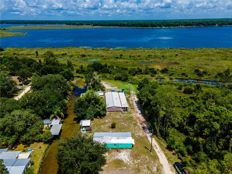 Kerr Key Classic is the perfect way to describe this cute 1965 mobile home with Keys feel and super clean with lots of updates. Outdoors includes 150' of canal water frontage with bulkhead, both open and covered Gazebo dock area with power, water and lighting, built in bench and fish cleaning station. Bring the fishing poles and cold beverages. Home includes 2 bedrooms, 1 bathroom with 612 square feet of living area. Spacious living room and open kitchen area with classic wood cabinets and lots of counter space. Main bedroom is cozy in size with a window AC unit. Bathroom includes tub/shower combo, wood cabinets, storage/linen closet and large counter space. 2nd bedroom is smaller and includes a large closet and storage. There is also an attached 144 sq ft bonus Florida/Dining room with canal views and the new owner could easily add an AC/Heat unit. This home is ready for guests with 2 RV hookups and a large covered front porch with LED lighting. Storage shed(12'x12') included as well with power and water hook-ups. Updates include new flooring throughout the main bedroom and hallway with drywall finishing and paint. Roof sealed in 2022. Lake Kerr is approx. 2800 acre spring fed lake and 2nd largest lake in Marion County. Located in the Heart of the Ocala National Forests. Lake Kerr also has access to Little Lake Kerr(Lake Werner). Some of the best fishing in Central Florida with largemouth bass, bream, catfish, specks and more to challenge you daily. Unique shape of the lake lends great opportunities for every kind of watersports including wakeboarding, waterskiing, canoeing, kayaking, tubing or just going for a relaxing boat cruise. There is only one public boat ramp(Morehead Park) with beautiful Kaufman Island located in the middle of lake.Located in the heart of the Ocala National Forest w/ beautiful Salt Springs swim area, boat launch and short ride to Lake George and the St. Johns River. Salt Springs is also home to miles and miles of ATV/SxS, Horseback and hiking trails. Great fishing year round in the many lakes, rivers and forest ponds, and don't forget about the excellent hunting too. Close to local shopping including grocery store, Dollar General, hardware, gas station, great restaurants, entertainment and more. Only a short 30 minute drive to Ocala or Palatka for all your needs.