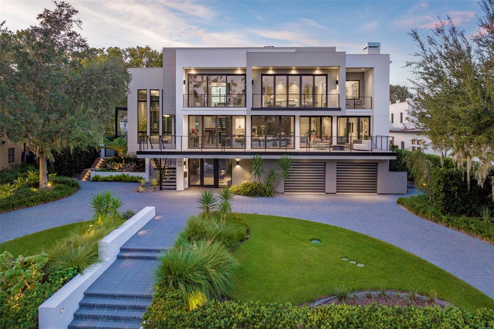 On the shores of Lake Sue, this fully furnished mid-century modern residence offers a rare lease opportunity blending architectural heritage with 21st-century innovation. Extensively remodeled by E2 Homes and completed in 2021, the home was originally designed by architect Roger Allen Leibin and reimagined as the award-winning New American Home Remodel. Showcasing cubed structural elements and serene lake views from each floor, the residence encompasses 6,709 square feet under air with a four-bedroom main house and a two-bedroom detached guesthouse. There are seven full baths and two half baths throughout the property. The open floor plan flows seamlessly to the outdoors, creating an effortless environment for gathering and entertaining. The gourmet kitchen features a spacious center island and professional-grade appliances. The owners’ suite is positioned to overlook the lake, offering a boutique-style dressing room and spa-like bath. Additional interior appointments include a glass wine cellar, wet bar and fireplace. Achieving a net-zero energy rating, the property is platinum-certified NGBS Emerald, DOE Zero Energy Ready, Indoor airPLUS qualified, Energy Star-certified and LEED Platinum certified. The newly added 875-square-foot cabana features a bedroom, two baths, full kitchen, home office or optional second bedroom, and a private dance or yoga studio. Outdoor amenities include a shimmering pool and spa, splash pad, gourmet summer kitchen, lanai and a private lakefront with dock, boat lift and dedicated waterfront lounge space. Monthly lease includes furnishings, all utilities, pool and yard maintenance, internet and streaming services and routine cleaning. No pets or smoking permitted. Please inquire for availability and additional terms.