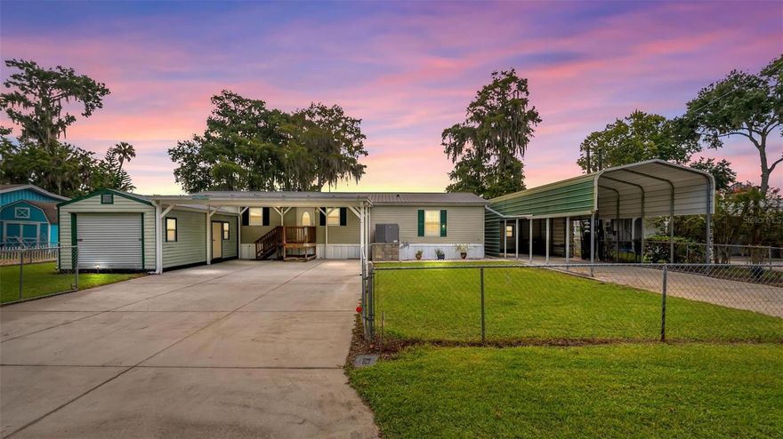 ATTENTION BOATERS AND WATER ENTHUSIASTS! Discover this WATERFRONT escape on the picturesque St. JOHN'S RIVER! This stunning RIVERFRONT home offers a premium, move-in-ready waterfront lifestyle, complete with a private, double, covered boat dock and a robust, upgraded metal seawall for ultimate peace of mind. Imagine morning coffee on your own dock or screened porch, sunset cruises from your backyard, and effortless access to all the St. Johns River has to offer. 3 bedroom / 2 bath, one-owner home has an open, split plan. large covered parking with fenced access. Large kitchen with a pantry is an entertainers dream! No shortage of cabinets and counter tops! Use the island to set out your spread for friends and enjoy the conversation while gathering to eat at the island. The large living / dining room area has 2 sets of sliding doors. No lack of view from anywhere! The spacious screened patio is perfect for entertaining, with the water as your magnificent backdrop. Recharge in the large Primary Bedroom with double closets, one being a walk-in, and a well appointed, roomy bath. 2 more bedrooms and a bath situated at the opposite end of the home for privacy. Utility room has large sink, washer and dryer hook-ups. The dock has double slips for those who can't decide if they want a ski boat or a pontoon! Both slips are covered and provide their own lifts. Dock also offers electric and water with a fish cleaning station. Plenty of room for a table, chairs and seating area, entertain or just enjoy a nice, quiet dinner on the water. Seawall is metal and newer and will provide years of utility. Covered RV Parking with electric hookup and dump station and a 19x11 utility or garden shed with electric attached. 25x25 covered parking to the house with a 23x11 utility building with water and electric, washer and dryer hook-up and a roll-up door. 
This property isn't just a home—it's a gateway to endless boating, fishing, and waterfront relaxation! It is the Florida Lifestyle you have been dreaming about! Metal Roof 2019. Seawall 2016. AC 2013. Irrigation well. Fenced.