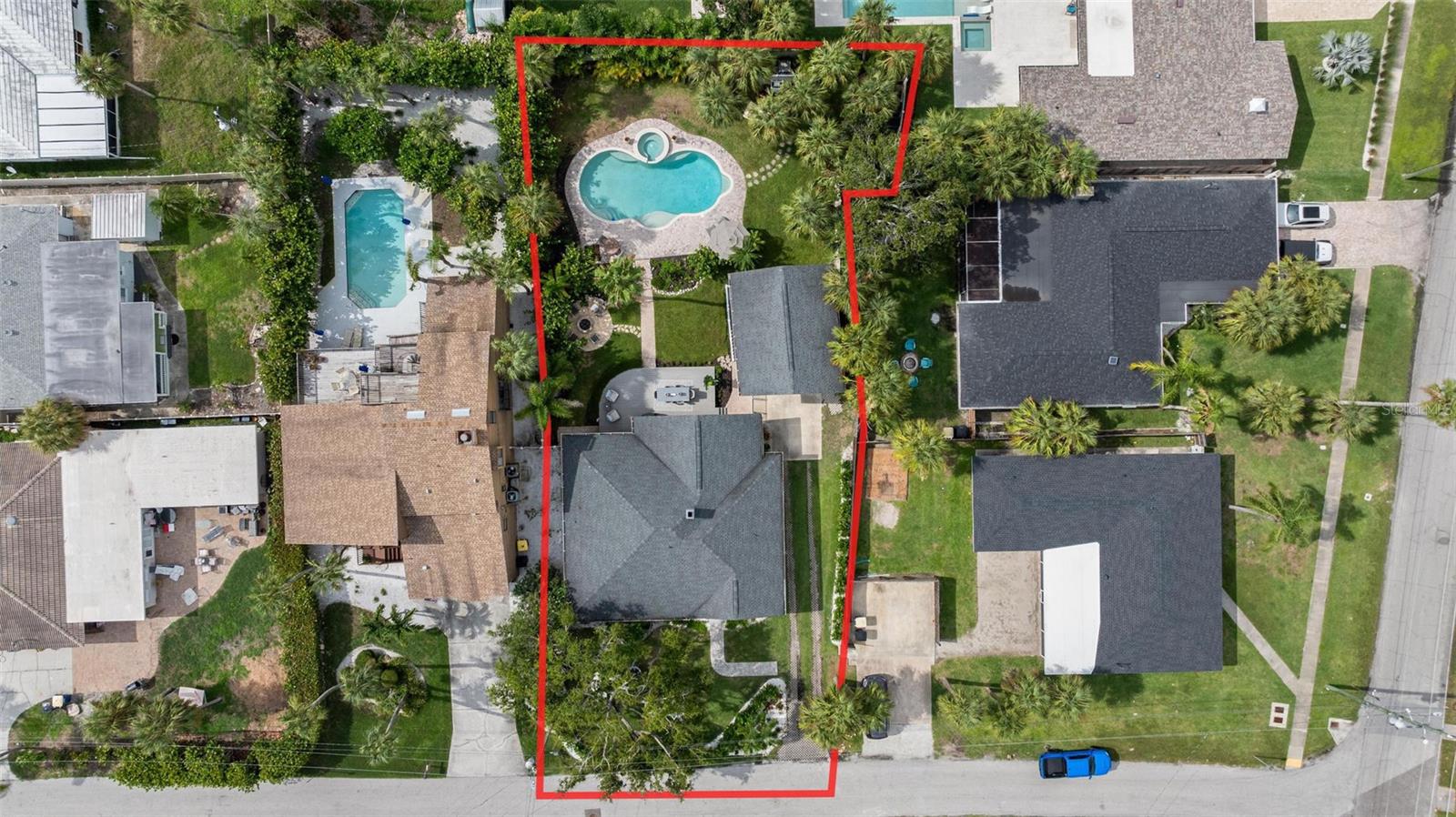 Your DREAM BEACH ESTATE is now available! As one of the MOST UNIQUE properties in ALL of Clearwater Beach, its palatial 0.29 acre lot, 3 bed/2.5 bathroom main house, and 1 bed/1 bathroom detached poolside ADU give you all the dynamic flexibility you want and need! Pulling up to the residence, the charming front porch facade welcomes you in and hides the resort-style backyard. Every square inch of the main house has been elegantly remodeled and strikes the perfect balance between warm coastal and modern luxury. The master suite has been tastefully remodeled with a deep blue accent wall, walk-in closet with custom built-ins, and a massive en-suite bathroom with a double vanity, luxurious clawfoot tub, and beautiful glass-enclosed walk-in shower. The brand new chef’s kitchen is the heart of the home with white shaker cabinets, hammered gold cabinet pulls, tasteful quartz countertops, and a lovely natural gas range. As you walk off of the kitchen into the dedicated dining room and separate entertaining space, you’ll notice and appreciate all the custom woodwork and framing throughout. Your guest bedrooms do not disappoint either and have great separation from the master bedroom with its ideal split floor plan. Heading outside, you will be in awe of the incredible backyard paradise! This decade-long landscaping project has culminated with a spacious elevated deck, directly piped natural gas BBQ grill, directly piped natural gas fire pit area for cool winter nights, a resort-inspired saltwater pool with spa, and an abundance of mature palms and flowers with bonus green space in the back corner of the property for kids and adults. The poolside ADU was built in 2014 and has a full living room, kitchenette with built-in office space, renovated bathroom with walk-in shower, and a full properly sized bedroom. Being within walking distance to the consistently ranked top beach in the country yet quietly tucked away in this quiet residential enclave, you get the best of both worlds! No HOA, no CDD, and zoned for 30 day minimum rentals. All that Clearwater has to offer: limitless restaurant options, bars, shopping, museums, aquarium, and entertainment for all ages, is all right at your fingertips. Don’t miss out on the opportunity to own this incredibly unique estate, book your showing today!