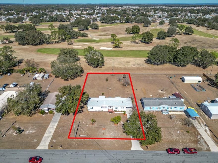 LOOKING FOR THAT SPECIAL NEW PROPERTY TO CALL HOME? BE SURE TO SEE THIS ONE! Spacious 3 Bedroom, 2 Bath Manufactured Home with Private Office and a Golf Course View of Spruce Creek Golf Course on a Beautiful 1/2 Acre Lot less than 2 Miles from The Villages! 1,716 of Sq Ft of living space, open split floor plan, large center island kitchen with plenty of cabinet storage, formal dining room, private office, inside laundry room and more... Key Upgrades: New Plumbing (2024), New Hot Water Heater (2024), New Roof (2023) and New HVAC (2022). Large Oversized Carport with concrete drive, fenced backyard and two large storage sheds for added convenience. LOW TAXES! NO HOA! NO CDD! NO BOND! NO LOT RENT! Located in Oakland Hills, a Family Friendly & Golf Cart Friendly Community. Just 7 minutes to The Villages Spanish Springs, dining, shopping, grocery stores, Villages hospital and Medical facilities.  Call to make an appointment to see this home today!