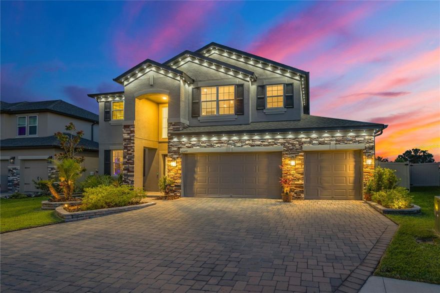 Step into luxury living in the heart of Epperson with this beautifully maintained 5-bedroom, 4-bath home offering nearly 3,800 square feet of thoughtfully designed living space and one of the most breathtaking sunset views in the community. Perfectly positioned overlooking King Lake, this home delivers a rare combination of space, upgrades, and a truly unmatched setting.

From the moment you enter, you're welcomed by a soaring entryway highlighted by a stunning chandelier that sets the tone for the rest of the home. The flexible floor plan features two spacious primary suites — one conveniently located on the first floor and another upstairs with sweeping lake views right from the owner's retreat.

The second floor also offers a large loft area perfect for a media room, game room, or additional living space. Throughout the home, pride of ownership is evident with meticulous maintenance and tasteful finishes throughout.

Designed for both relaxing and entertaining, the covered rear patio with upgraded pavers creates the perfect outdoor space to enjoy the incredible water views and unforgettable sunsets. The entire exterior is enhanced with professionally installed accent lighting, giving the home exceptional curb appeal day and night.

Additional features include a spacious 3-car garage with ample storage and a Tesla charging station already installed for added convenience.

Located within the highly sought-after Epperson community, this home offers a rare opportunity to own one of the area's best lake-view properties while enjoying resort-style amenities, nearby shopping, dining, and easy access to everything Wesley Chapel has to offer.