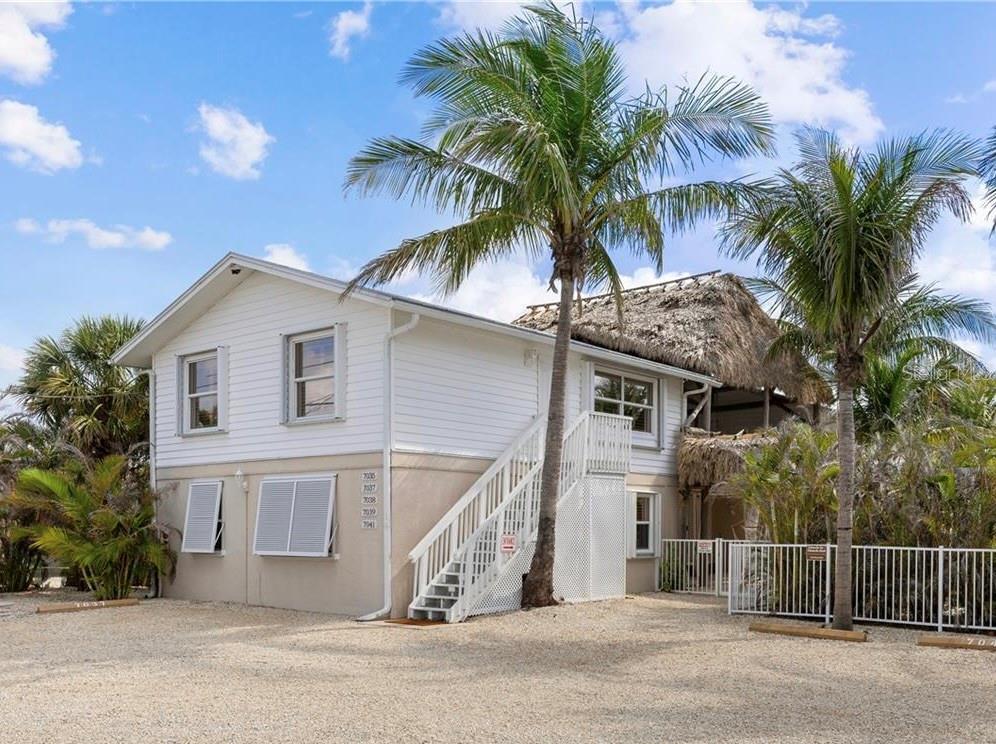 Welcome to your DREAM INVESTMENT in Cape Haze Placida, Englewood! This Double Duplex (Quadplex) offers 4 tropical apartments with a total of 6 bedroom/4.5 baths and strong rental income! It is Zoned Commercial (CG), but grandfathered Residential, so the opportunities of what can be done with the property are endless! Rent EITHER long term or short term! 6 Off-Street Parking spaces. Visitors will love the tropical atmosphere throughout! A two-story Tiki Hut connects the two buildings and offers a relaxing covered outdoor experience. All Tiki structures were built in 2019. Most of the interiors were updated in 2018/2019. There are TWO 2 bedroom apartments and TWO 1 bedroom apartments that have similar layouts and furnishings plus an incredible amount of common space. Each unit has its own private outdoor hot tub, located in exclusive areas around the well landscaped lot. Guests will enjoy the variety of fruit trees, palms, BBQ area, sitting areas and incredible lighting at night! Owners will appreciate the lack of maintenance required due to the weed barrier and lime-rock. As you step inside each unit, you'll be greeted by an open floor plan that seamlessly blends indoor and outdoor living. The large kitchens are a chef’s delight with stainless steel appliances and plenty of countertop space/cabinets. Units are fully furnished with Central AC. There are PGT hurricane impact windows (tinted) and shutters, plus a separate laundry room with two commercial washers and two dryers (bought last year). Also a separate half bathroom for guests to use when outside. This one-of-a-kind property could either be used as a tropical vacation rental property, as a seasonal second home, or run it fully commercial. Seller is including all furnishings, 4 jacuzzi’s, property website, plus short term rental property pages e.g. VRBO & Google Maps with lots of five star reviews. 2 units can be combined and rented together to one party as a 3 bedroom/2 bath, or the entire complex can be rented to one party as a 6 bed/4 bath. One of the commercial signs on the street advertising the property is also included in purchase. AREA: The location is incredible! Pura Vida is conveniently located near beautiful sandy beaches, including Boca Grande, Little Gasparilla Island, Don Pedro Island (Palm Island) and Manasota Key (Englewood Beach). The Cape Haze Aquatic Preserve, known for its rich biodiversity, provides the perfect backdrop for kayaking, fishing, and wildlife observation. Just across the street is Palm Harbor Marina (Loggerhead), Marine Max and Cape Haze Marina. Nearby beaches include: Boca Grande, Palm Island or Englewood beach! Visitors can walk to the Palm Island ferry and the water taxi. Other fun options include: Shopping, great restaurants and numerous golf courses, Also easy access to the Gulf and the stunning waters of Lemon Bay and Boca Grande. Whether you’re looking to relax in nature or engage in exciting recreational pursuits, Cape Haze, Placida, Englewood truly has something for everyone, embodying the quintessential Florida lifestyle. There is an address for each of the 4 units: 7035, 7037, 7039 and 7041 Placida Rd. Seller has recently passed 4 point inspection. No flood claims with current owner. Units currently rented short term. Guests are currently staying at the property. Contact the agent for all showings.
