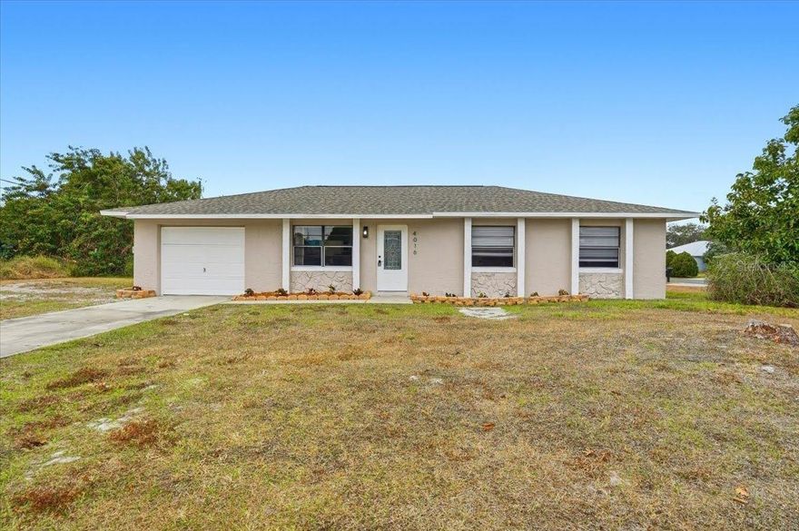 Beautiful 3 bedroom/ 2 bathroom concrete-block home with a 1 car garage, screened-in lanai out back, situated on a large corner lot! Inside you'll find an upgraded home with tile flooring throughout, new interior paint, and vaulted ceilings that open up the place and give it a welcoming feeling. Lovely galley style kitchen with plenty of cabinet space. The sliding glass doors in the dining area open into the screened lanai where you can lounge and enjoy a morning coffee. Spacious master bedroom has an attached bathroom with stand-in shower. Hallway bathroom has been remodeled with a new retiled shower, new mirror, and new vanity! BRAND NEW HVAC and water heater! 2017 Roof in good condition! This could be your perfect home- easy to see! Schedule a showing now!