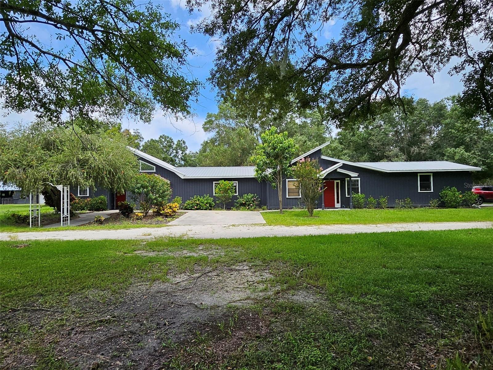 Beautiful farm living on a corner lot with an abundance of shade provided by oak trees, cleared land to run and graze your horses, a stocked pond for fishing, a seperate in-law suite with kitchen, walk in closet, and its own bathroom, a large pole barn, two seperate screened in porches, two seperate garages (2 car garage attached to the house and a 1 car garage in the barn), tact room, seperate office area, joint living area for entertaining, 6 stall barn with metal roof (30x36 Barn, 12x30 enclosed), completely fenced property with 5 seperate paddocks, the amenities of this property are abundant. This 5 bedroom 3 bathroom equstrian estate has everything you could ask for including comfort and convenience. Located close to town but still nestled in the picturesque open landscape that is Arcadia this propety offers a serene retreat for those who want acrage and tranquility.