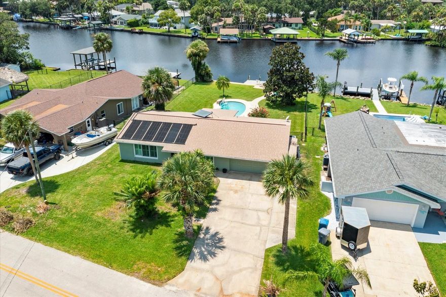 How do you price a lifestyle that offers true peace and serenity all while delivering nightly sky carved sunsets? This home, nestled right into Ormond Beach, is a direct waterfront paradise ready for new owners to make it their own! There's one critical requirement.... MUST LOVE THE WATER! You're surrounded by the timelessness of the Old Florida waterways where you can watch endless variations of wildlife make their homes in and around the coast! Sit on your very own private dock after a day on your boat. The boat lift will afford you the ability to take your boat out of the water for safekeeping and proper maintenance. Refresh in the inviting heated inground pool! This 3 bedroom, 2 bath home features an upgraded kitchen, flooring, baths and boasts hurricane rated windows adorned with Plantation shutters! The two-car garage offers plenty of storage, but for the additional water toys you'll be tempted to own, there's additional storage built in along the north side of the home. Septic and well maintained, has a Kinetico soft water system, irrigation sprinkler system plus irrigation well too! Short boat ride to local restaurants and state parks and out to the Intracoastal Waterway. This waterfront oasis defines the calm and tranquility of an Old Florida lifestyle, yet still appeals to the masses with modern amenities. Don't miss out on an opportunity to tour this home! All information and measurements taken from the tax roll and seller, and while deemed reliable, cannot be guaranteed.