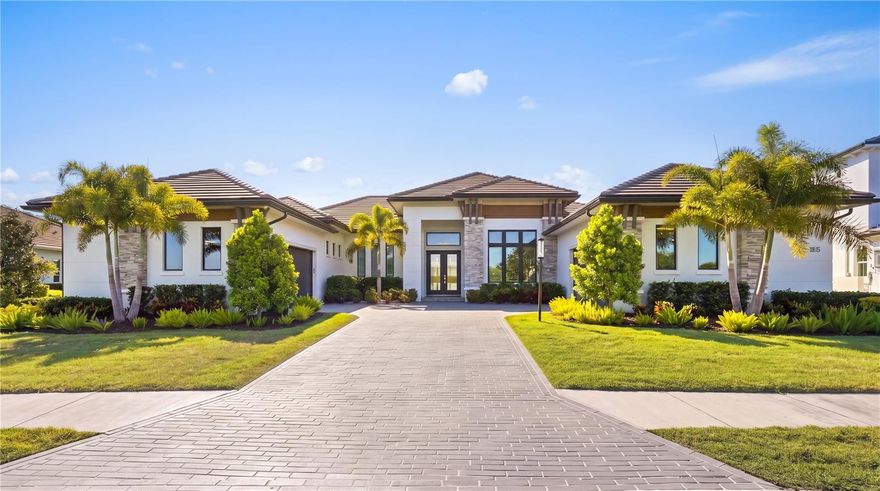 Custom built in 2024, this luxury John Cannon Homes Tindarra model estate is designed for refined Florida waterfront living—where architectural elegance meets a seamless, open-concept flow. Richly detailed yet timeless, the residence captures breathtaking western sunset views along a canal with direct access to the Manatee River, delivering a rare expression of luxury waterfront real estate, boating lifestyle, and the ultimate Florida living experience.
Located in The Islands on the Manatee River, an award-winning, gated waterfront community recognized as Best Overall Community (category 3) in the 2026 Parade of Homes for the 8th year, this exceptional residence spans 3,612 square feet under air (5,291 square feet total). The thoughtfully designed split floor plan offers three spacious bedrooms with their own en-suites plus a full pool bath, ideal for both privacy and entertaining. Upon entry, the home makes an immediate impression with custom inlay wood flooring, designer molding, and a grand great room with soaring 11-foot ceilings, a sleek electric fireplace, and expansive water views. The space flows effortlessly into the dining room and then into a chef’s kitchen designed for entertaining, featuring solid wood white cabinetry, premium Dacor appliances (six-burner gas range, electric wall oven, warming drawer, microwave, and built-in refrigerator) along with a discreet hideaway pantry for added function and elegance.
An expansive bonus room extends the living space—perfect as a media room, club room, or sunset lounge—framing picturesque canal views and golden evening skies. A private study/den with sliding glass doors opens to the lanai, offering a flexible home office or quiet retreat. The expansive owner’s suite is a true sanctuary, featuring private lanai access, dual custom walk-in closets, one with a 9 x 15 boutique-style dressing space with chandelier. The spa-inspired primary bath showcases a walk-through double-entry shower, soaking tub, and dual vanities, blending luxury with everyday comfort.
Car collectors and hobbyists will appreciate the dual two-car garages (4-car capacity) with a 14’ paver driveway and additional overhead storage via pull-down access. Outdoors, the home transforms into a private resort-style retreat, featuring an expansive 1,008 square foot lanai, a fully equipped outdoor kitchen, and multiple seating areas ideal for entertaining. Trex decking leads to a private, lighted dock with a 15,000 lb vertical boat lift, power, and water, with dual access points for ease of onboarding.
Additional features that deliver both peace of mind and modern convenience include PGT impact windows and doors, smart home wiring (Cat6), kitchen and lanai overhead speakers, security system, custom lighting, dimmable recessed lighting, crown molding, ceiling fans, low-voltage window coverings, 500 gallon buried propane tank and a private irrigation well.
A rare opportunity to own a like-new construction waterfront estate, this home offers the perfect blend of luxury, functionality, and lifestyle—an exceptional boating home, canal-front property, and sunset-facing residence designed to be as effortless as it is extraordinary.