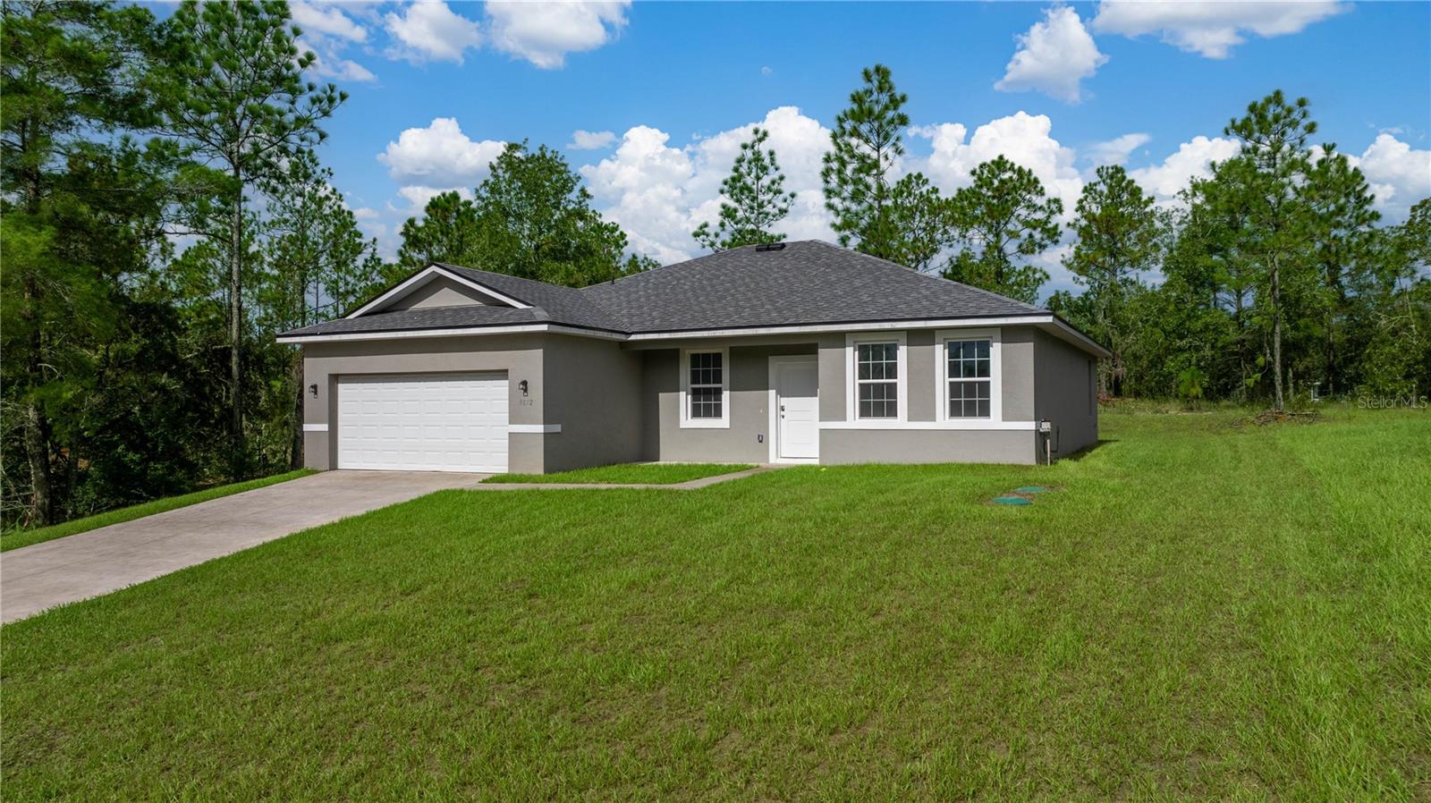 Bring the family to this Brand New Construction, 4 bedroom/3 bath Home in Citrus Springs. High & Dry. NO Flood zone. If you can’t have a mother-in-law suite, here’s the next best thing- An ENSUITE! With it’s own bathroom & large walk-in closet. Or, great for a home office! This Open Floor Plan offers a Covered Porch and Covered Lanai off the kitchen. Tall ceilings throughout, 9”4”. Ttile throughout! No carpet! Builder Warranty. Closing cost assistance or buydown with acceptable contract! This home is eligible USDA, VA, FHA!
