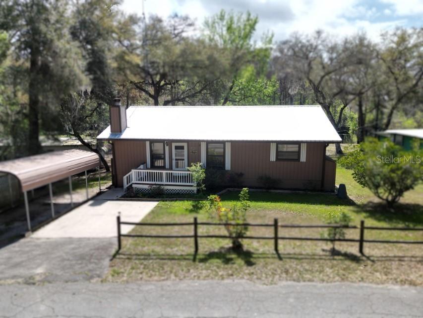 Riverfront Paradise with Stunning Views & Unique Features – Motivated Seller! Welcome to 9461 CR 657 in Bushnell, FL—a beautifully renovated riverfront retreat offering peace, privacy, and panoramic views of a 50-acre bird sanctuary across the river. Perfect for nature lovers, this home invites you to unwind in a serene setting where wildlife and water views are part of daily life. Built in 1985 and thoughtfully updated, this charming single-family home features 3 bedrooms, 2 full bathrooms, and nearly 2,000 sq ft of living space. The open-concept layout includes a spacious living/dining combo and a cozy family room with a wood-burning fireplace, all enhanced by durable ceramic tile flooring throughout. The fully-equipped kitchen boasts granite countertops, a large island, and modern appliances—perfect for entertaining or casual family meals. The oversized primary suite offers breathtaking river views, built-in closets, and an ensuite bathroom. An adjoining bonus room makes an ideal nursery, home office, or private retreat. Set on a 0.28-acre lot, the fenced yard offers a safe space for kids and pets to play. A new metal roof (installed with a 20-year warranty) adds peace of mind, while the rare-for-Florida 500+ sq ft basement (with exterior access) provides incredible flexibility—use it as a workshop, man cave, or extra storage, complete with workbench, sink, and second refrigerator/freezer. Additional features include a covered carport, well and septic, and a low-maintenance wood exterior. Located in the welcoming River Retreats community, this home is ideally positioned between Tampa, Orlando, and Ocala. Enjoy nearby conveniences like shopping (15 minutes), The Villages (30 minutes), Brooksville Country Club golf & tennis (17 minutes), and multiple hospitals—all within a 30-minute drive. Zoned for Bushnell Elementary, South Sumter Middle, and South Sumter High. And while it sits directly on the river, this home has never experienced flooding. Don’t miss this unique opportunity to own a true piece of Florida’s natural beauty—schedule your showing today!