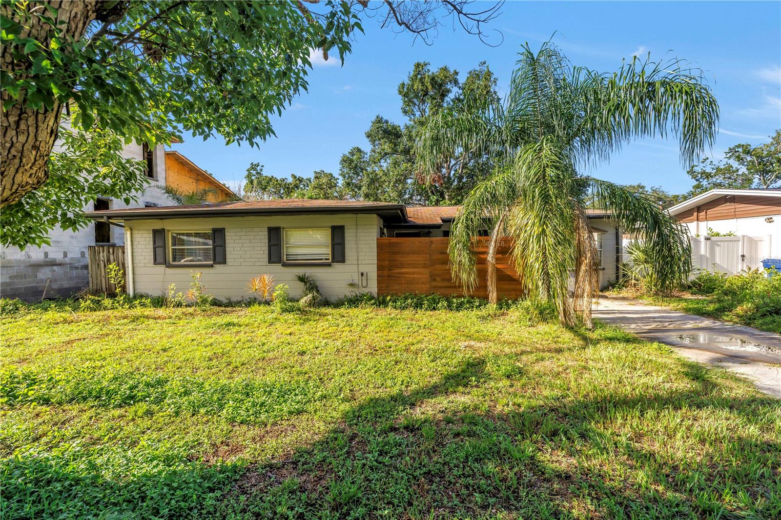 Discover the perfect blend of mid-century charm and modern luxury, nestled in Tampa’s desirable 33611 neighborhood. Updated inside, this home features sleek luxury vinyl plank flooring throughout, raised-panel kitchen cabinets topped with gleaming granite counters, and stainless steel appliances. The bright, open living and dining areas are bathed in natural light through classic picture-frame windows and large glass sliding doors that seamlessly connect to an expansive, fenced backyard complete with a generous deck and mature shade trees. Spa-inspired bathrooms have been fully remodeled with premium fixtures and contemporary finishes, and all three spacious bedrooms, including the primary suite, offer comfort and style. For your peace of mind, the seller has already completed every inspection, roof, 4-point, and more. All reports are available for review. With central HVAC, a flexible floorplan offering room for expansion, and a turnkey presentation just minutes from downtown Tampa, Seminole Heights dining, and South Tampa’s shops and parks, this Coachman Avenue gem is ready for you to move right in and live beautifully. Schedule your private tour today!