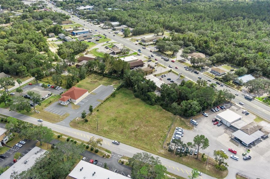 High-Exposure Commercial Development Site | SR 44 | Inverness, FL | Tampa MSA
Located directly on heavily traveled SR 44, just a few parcels from a controlled intersection, this property offers exceptional accessibility and visibility to a broad customer base within Inverness, in Citrus County. The subject property totals ±0.67 acres and is zoned C-Commercial within the city limits of Inverness, with the ability to connect to newly expanded municipal water and sewer services.

The site features approximately 150 feet of frontage on SR 44, boasting ±29,560 AADT, and provides unrestricted ingress and egress for both eastbound and westbound commuter traffic—an increasingly rare attribute along this corridor. With commercial zoning, jurisdictional utilities, and strong access, the property is well suited for a variety of uses including QSR with drive-thru, restaurant (up to ±2,000 SF), retail, medical or professional office, automotive, and other service-oriented commercial uses.

The property is strategically positioned near Historic Downtown Inverness, home to major civic and institutional anchors including Citrus Memorial Hospital, the Citrus County Courthouse, the Tax Collector’s Office, and City Hall. Within a two-mile radius, the area supports a strong national and regional retail presence featuring Walmart, Lowe’s, TJ Maxx, multiple grocery stores, quick-service restaurants, and sit-down dining options.

Within a 15-minute drive, the property serves a population of approximately 36,848 residents, with a median age of 64 and median household income of $52,000, growing at an annual rate of 2.93%. Local consumer expenditures for healthcare exceed $57 million annually, with more than $20 million dedicated to physician services, reinforcing the area’s strength for medical, wellness, and professional uses.

The City of Inverness has made significant public investments in revitalization, including newly constructed lakefront amenities such as Liberty Park, Wallace Brooks Park, and the Depot District, enhancing quality of life and long-term economic vitality. Additionally, the recent $135 million expansion of the Suncoast Parkway, along with planned future extensions, positions Citrus County for continued growth as part of the Tampa–St. Petersburg–Clearwater MSA.

Within an expanded 15-minute trade area, the property captures an ideal customer base of approximately 46,361 residents, with an average age of 58 and median household income of $65,000. Consumer data indicates that 66% of residents dine at sit-down restaurants, 89% frequent fast-food establishments, and healthcare expenditures exceed $106 million annually, driven by the area’s age-weighted demographics.

The site also provides convenient access to surrounding communities including Floral City (5 miles), Lecanto (12.3 miles), Beverly Hills (15.1 miles), Crystal River (16.6 miles), and Homosassa (18.8 miles). Citrus County, currently home to approximately 153,600 residents, is projected under the County’s Land Development Code to accommodate population growth approaching 350,000 residents by 2030, further strengthening long-term demand fundamentals.