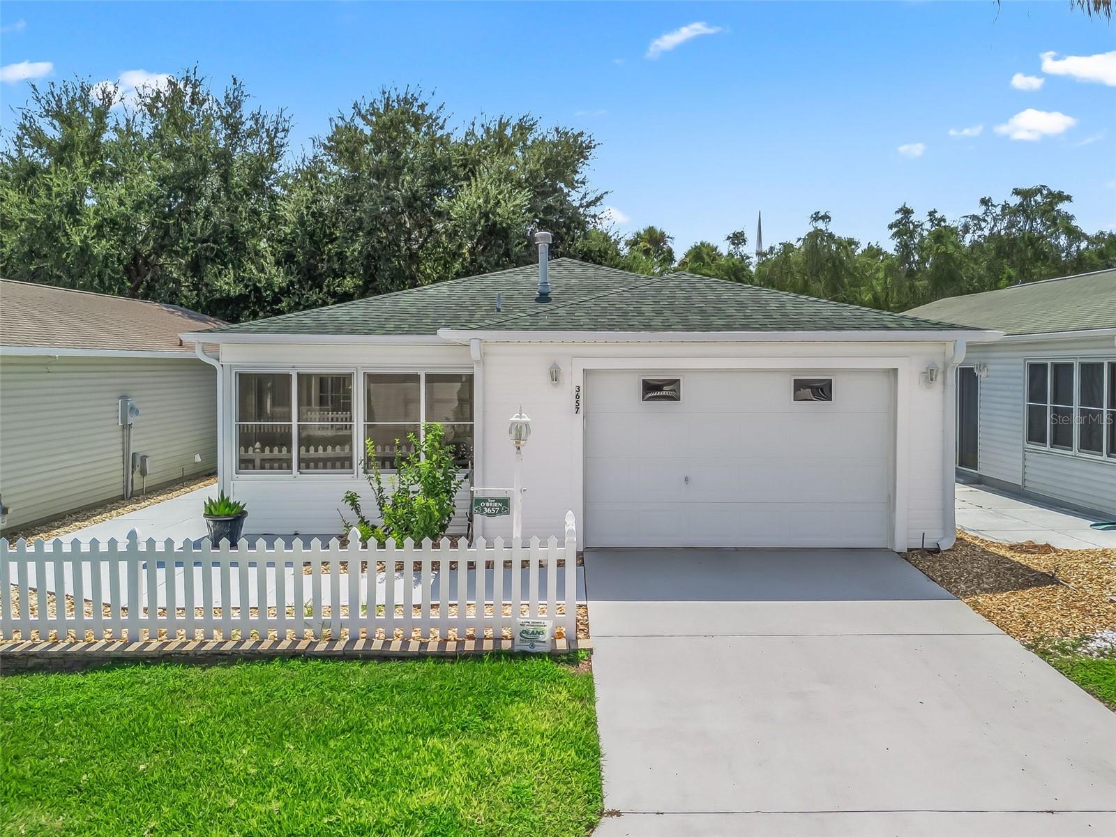 TURN-KEY, IMMACULATE, COLONY VILLA in the Village of SUMMERHILL! This beautifully maintained 2-bedroom, 2-bath villa offers the perfect combination of comfort, style, and convenience. Natural light fills the home through solar tubes in the kitchen and bathrooms, creating a bright and inviting atmosphere. The stunning kitchen features stainless steel appliances, a brand-new deep stainless sink, complementary backsplash, high-definition countertops, closet pantry, and laundry area tucked neatly behind bi-fold doors. The primary suite includes a walk-in closet and a private bath with step-in shower, single vanity, and solar tube. Tile flooring flows throughout the main living areas for easy care with wood like laminate in the two bedrooms. The glass-enclosed front lanai with sliding windows is perfect for added enjoyment, and the expanded concrete patio provides additional outdoor living space. Stone-filled landscaping keeps the exterior low-maintenance, leaving you more time to enjoy everything The Villages has to offer. Roof-2017, HVAC-2013, HWH-2016, Garage door opener-2024, Garbage Disposal-2024, Yamaha GAS GOLF CAR INCLUDED-2016. Conveniently located just behind Southern Trace Shopping Center, minutes from the new Costco, and close to golf courses, pools, shopping, and dining — this villa is a must-see!