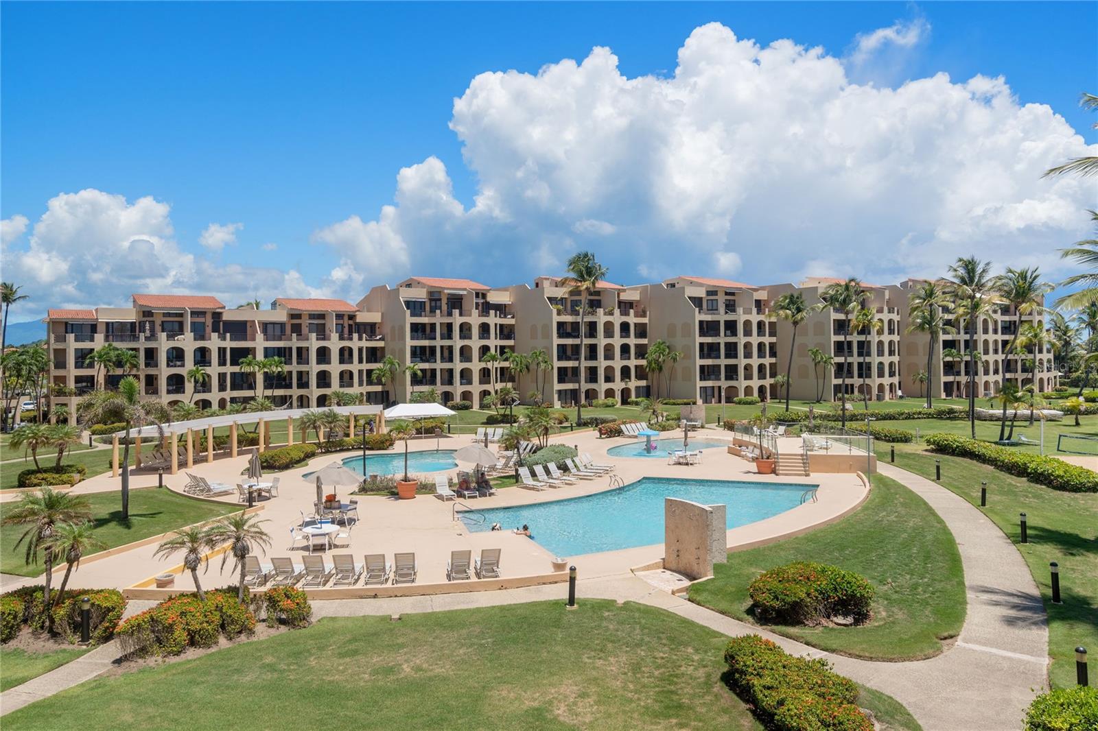 This sought-after turn-key beach residence has two-suites with two-ensuite bathrooms. It is one of the most acclaimed at Crescent Beach in Palmas del Mar Resort due to its location and the beach-facing terrace. It is fully equipped; it is from where you can experience the stunning views of Vieques Island and also located in front of the enjoyable pools. The modern kitchen and dining-living rooms experiences certainly give the residence the harmony and the coziness of a beach home. The primary bedroom is strategically located and has a conveniently renovated bathroom with a modern-open shower and ample walking closet.
This community offers a serene, resort-style lifestyle where the Caribbean Sea becomes your backyard. Residents enjoy direct access to a quiet, swimmable beach, stunning ocean views from spacious balconies, and the convenience of amenities like swimming pools, walking paths, and 24/7 gated security. The relaxed pace of coastal living is complemented by the vibrant offerings of the Palmas del Mar community, including golf courses, restaurants, a marina, and more. The beachfront living comes with the natural beauty, health benefits, and rental potential make it a rewarding and immersive experience for those seeking Beauty, Peace and Freedom in a tropical lifestyle.