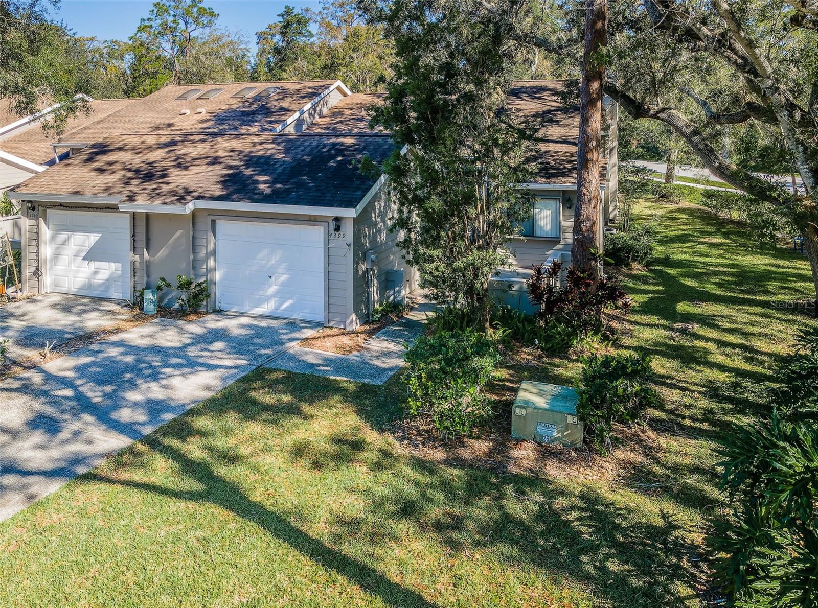 New Roof 2025! Welcome to 4399 Brooker Creek Drive – a charming 2-bedroom, 2-bath villa offering 1,440 square feet of bright, airy living space in Palm Harbor’s sought-after Brooker Creek community. Nestled against a peaceful creek and preserved wooded area, this home provides a unique blend of serene nature and modern convenience.
Step into a bright interior where vaulted ceilings and expansive windows invite abundant natural light. The inviting living area, highlighted by a cozy wood-burning fireplace, creates a warm atmosphere perfect for relaxing evenings. The adjacent kitchen is designed for both function and style, offering ample counter space and cabinetry, while a sunny breakfast nook overlooks the front courtyard—setting the stage for leisurely mornings.
The thoughtfully designed split-bedroom layout ensures privacy. The spacious primary suite features a large walk-in closet and an en-suite bath equipped with dual sinks and a walk-in shower. The second bedroom, equally comfortable and bright, is ideal for guests or a home office.
Outside, enjoy direct access to a sparkling community pool and at the end of the street, private neighborhood entrances that lead to John Chesnut Park—a 255-acre natural retreat with trails, picnic areas, and lakeside fun. Imagine relaxing on your rear porch, soaking in peaceful creek views and watching local wildlife, all while having nature at your doorstep.
Designed for both comfort and peace of mind, this well-built home has proven its durability by weathering recent hurricanes with ease. Recent touches—including fresh neutral paint, a new garage door, and updated door hardware—enhance its appeal while preserving its original charm. Priced attractively at $275,000, this villa presents exceptional value.
Positioned on a quiet cul-de-sac, you’re just minutes from the local YMCA, premier golf courses, shopping, and dining. Plus, you’re within easy reach of Gulf Coast beaches and Tampa International Airport—truly the best of Florida living.
Discover your own slice of paradise at 4399 Brooker Creek Drive. Whether searching for a year-round residence or a seasonal retreat, this home invites you to embrace a relaxed lifestyle surrounded by nature and modern amenities. Schedule your private showing today and experience all that this unique property has for you! HVAC and Water Heater 2017.