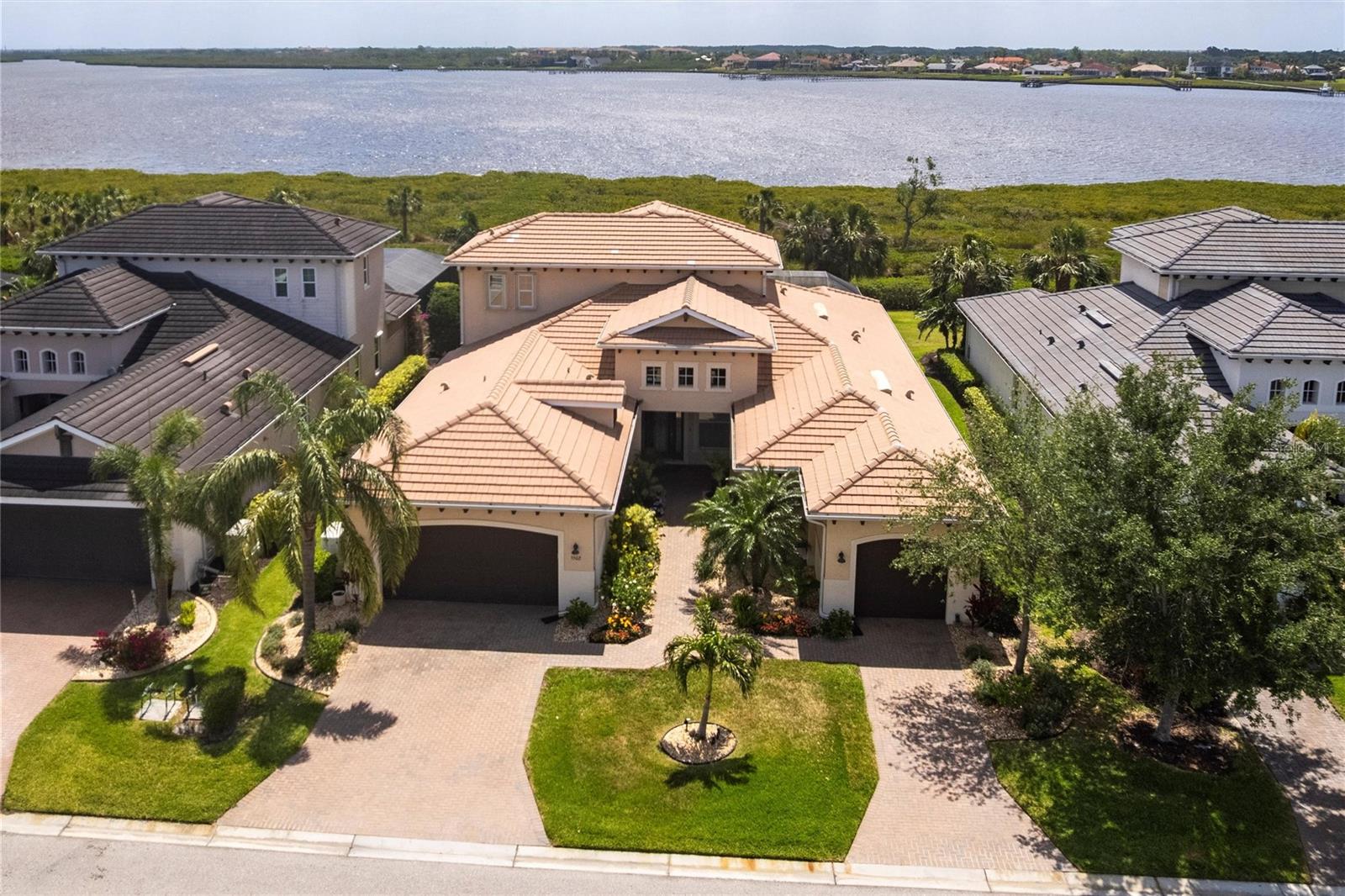 What if every day felt like a five-star escape? Welcome to your private sanctuary in Tidewater Preserve—Bradenton’s coveted gated, non-CDD waterfront community, where elevated coastal living meets timeless elegance. This exceptional two-story waterfront saltwater heated pool home showcases refined design and modern luxury, offering 3,460 sq ft of beautifully curated living space. With three bedrooms + den, a bonus room, 4.5 baths, and a 3-car garage, the residence blends comfort, privacy, and sophistication in one stunning package. Perfectly positioned to capture sweeping views of protected preserves and tranquil waterways, this home is truly a retreat. Inside, you’ll find an open, airy floor plan enhanced by floor-to-ceiling windows, flooding the interior with natural light and framing the surrounding beauty. Every space is elevated with designer finishes, clean architectural lines, and a calm, coastal palette. At the heart of the home, the gourmet kitchen impresses with stainless steel appliances, quartz countertops, an induction cooktop, an electric oven, customized pantries, pull-out drawers for organization, and a large island ideal for casual mornings and elegant entertaining. The owner’s suite is a sanctuary, featuring peaceful water views, ensuite bath, and dual custom walk-in closets. Two generously sized guest suites each feature their own ensuite bathroom, providing a luxurious and serene enclave for your guests. Upstairs, a bonus room offers flexible space for a media lounge, game room, or private retreat with a full bath. Enjoy two stunning lanai areas, thoughtfully designed to capture water views from every angle—complete with a fully equipped outdoor kitchen, perfect for sipping coffee at sunrise or unwinding with cocktails at sunset. Additional features include: New Pool Pump (2025), Newer Pool Heater (2024), Complete Storm Protection, Security System, Indoor/Outdoor Speakers, Whole-house Generator, Custom Lighting, Plantation Shutters, Crown Molding, Water Filtration System, Automated Lanai Screens, Central Vacuum, Custom Closets, and Much More! As a resident of Tidewater Preserve, you’ll enjoy exclusive access to a private marina, two clubhouses, Har-Tru tennis courts, fitness centers, kayak launches, nature trails, and more. This is just minutes from downtown Bradenton, the charm of Lakewood Ranch, and the world-renowned beaches of Anna Maria Island.