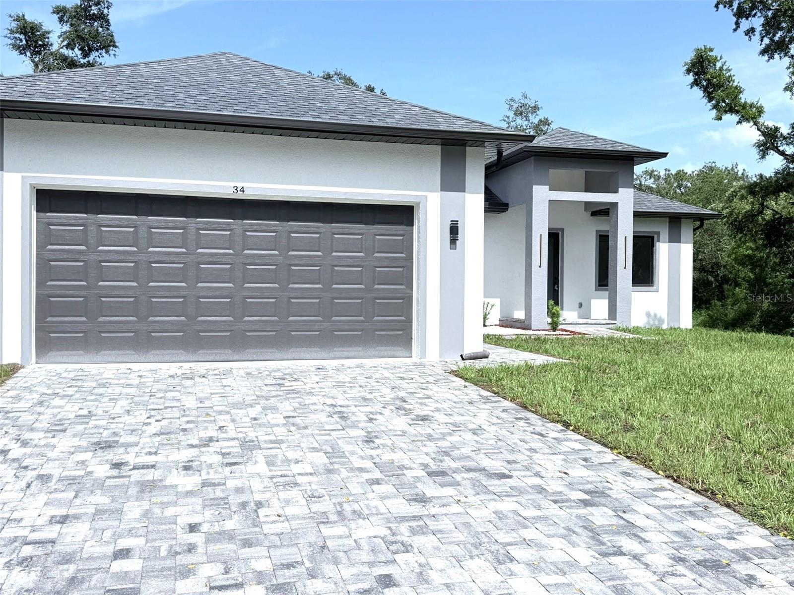 Introducing a newly constructed four-bedroom, three-bath residence on a freshwater canal in the heart of Port Charlotte. Spanning 2,153 square feet of living space and totaling 3,099 square feet, this home combines modern architecture with function and refined detail. The open-concept floor plan seamlessly integrates the living and dining areas, creating an inviting space for daily living and entertaining. A gourmet kitchen anchors the interior, featuring state-of-the-art stainless steel appliances and luxury finishes. High-quality vinyl flooring runs throughout, complementing soaring 10- 12- and 13-foot ceilings that enhance the home's scale and light. The primary suite is a private retreat with a spa-style bath including a soaking tub, walk-in shower, double vanity and an oversized walk-in closet. Additional features include a laundry room with sink and pre-designed layout for future home enhancements. Thoughtful exterior design includes modern elevation details, sliding windows, a metal and glass front door, soffit lighting in the rear area and strategically placed gutters. The home sits on a site ready for a pool and has summer kitchen connections ready and water softener installed. Built in 2025 with an emphasis on craftsmanship and contemporary design, this property presents a rare opportunity to own a new construction home in an established area of Port Charlotte.