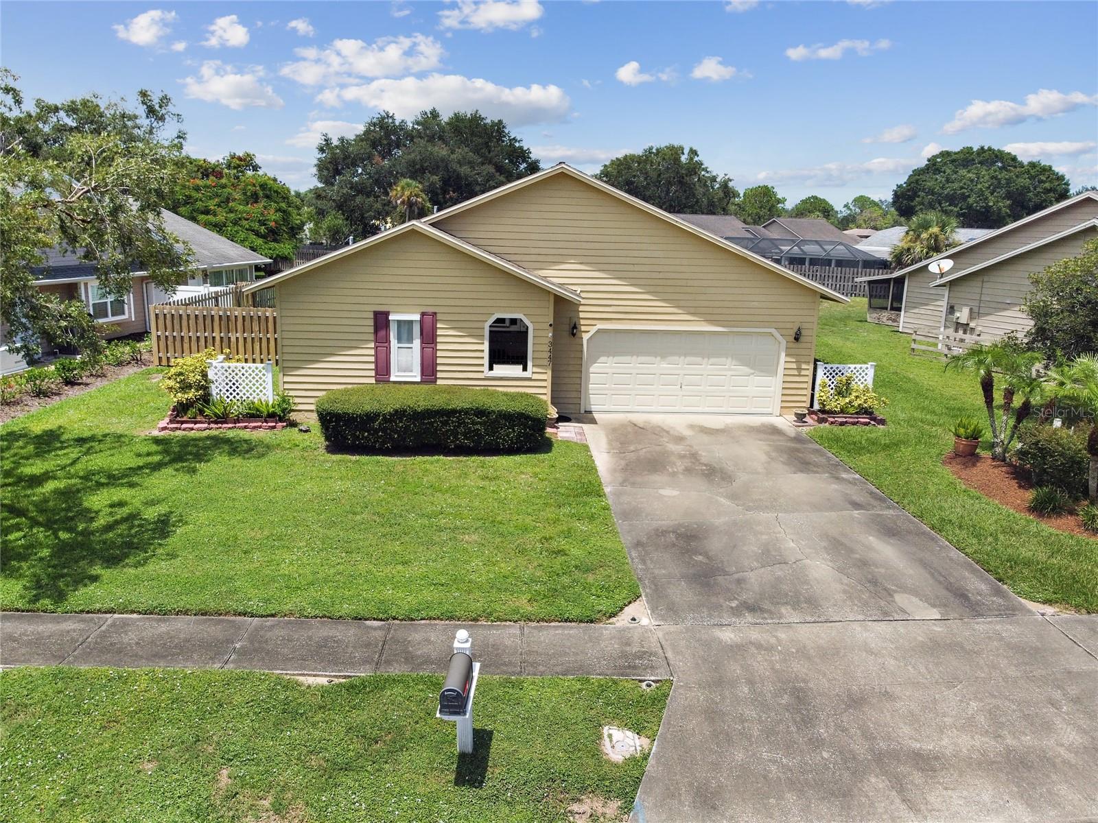 MULTI-GENERATIONAL GEM WITH LARGE BACKYARD – Nestled in a quiet Titusville neighborhood, this thoughtfully designed 3-bedroom, 3-bathroom home delivers comfort, versatility, and true Florida charm. Perfect for multi-generational living, it features an ATTACHED IN-LAW SUITE with its own private entrance, separate AC system (new in 2025) and water heater (2017), wood flooring, and a full bedroom and bathroom, perfect as a guesthouse, home office, caregiver quarters, or even an income-producing rental. The possibilities are endless! A welcoming courtyard entry with a deck added in 2024 sets the tone, leading you into the main living area where a stunning vaulted, TONGUE-AND-GROOVE CEILING adds warmth and architectural character. The open flow is enhanced by tile flooring throughout the main home for easy maintenance and a timeless look. The open-concept kitchen offers a breakfast bar, a refrigerator and convection stove from 2021, and custom cabinet details that make meal prep a delight. Situated on OVER A QUARTER-ACRE LOT with an irrigation well for sprinklers, the property offers both privacy and the perfect canvas to design your dream backyard paradise whether that’s a lush garden, sparkling pool, outdoor kitchen, or all three. The two-car garage provides ample storage, while the FULLY FENCED BACKYARD is perfect for gatherings, pets, or peaceful relaxation. Enjoy Florida’s indoor-outdoor lifestyle year-round in the SCREEN-ENCLOSED, COVERED PORCH, ideal for morning coffee or evening unwinding. For peace of mind, HURRICANE SHUTTERS are included to protect your investment during storm season. With its smart layout and unique combination of shared and private spaces, this property adapts to your needs whether that’s hosting guests, working from home, or pursuing hobbies. Conveniently located near local parks, shopping, dining, and just a short drive to Space Coast beaches and the Kennedy Space Center, this home blends serenity with accessibility. DON’T MISS YOUR OPPORTUNITY – SCHEDULE YOUR TOUR TODAY!