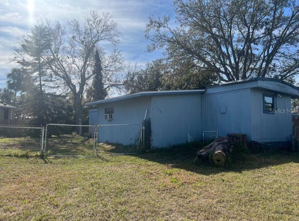 This newly renovated single wide mobile home sits on a street in highly desirable Port Orange. A private entrance and stone pathway invite you into a fully fenced yard. Upon entrance, you are warmly greeted by floating floors, fresh paint, and a bright and open floor plan seamlessly connecting the kitchen to the living room. Meticulous attention to detail is presented in the livingroom with new renovated walls, The kitchen is freshly painted, clean cabinets, and complete with appliances. Adjacent to the living room, there’s a comfortable oversized addition. Proceeding down the hall You’ll find a bathroom, and two bedrooms, that provide additional flexibility. The backyard features a front porch, back porch and a deck with a large detached shed for extra storage or work space. Enjoy the serenity of neighborhood living while being just a short drive from vibrant community centers. Recent remodeling adds to the homes value and appeal. Contact us today for more information.