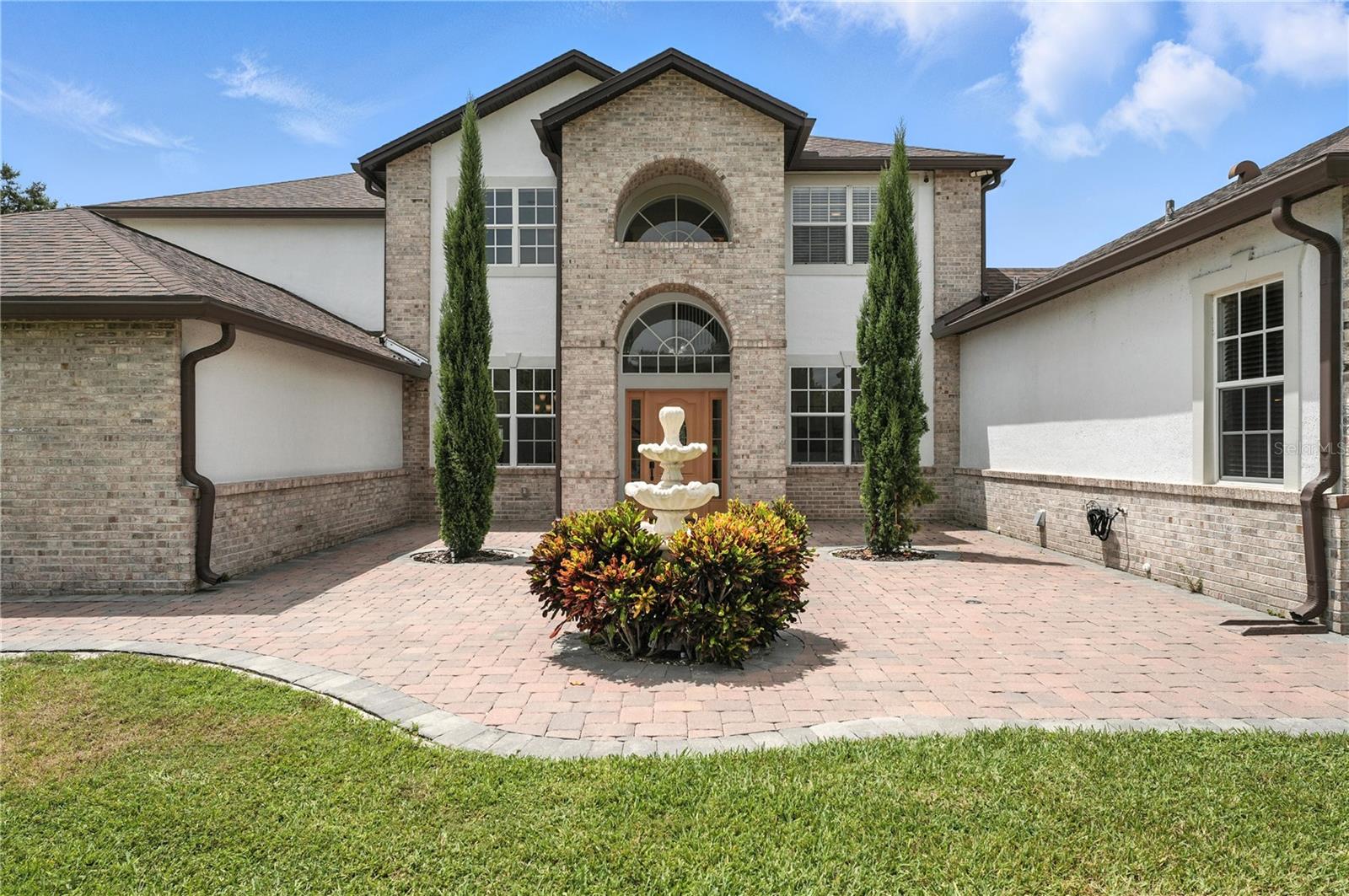 Welcome a one-of-a-kind luxury equestrian estate nestled on 2.41 pristine acres in the Trails of Montverde. Offering the perfect blend of resort-style living and equestrian functionality, this private cul-de-sac property is thoughtfully designed for those who demand excellence in both lifestyle and land.
Step inside a CUSTOM-BUILT home where timeless design meets modern sophistication. With 5 bedrooms and 3.5 baths, this estate includes a PRIVATE IN-LAW SUITE featuring a full kitchen and separate entrance—ideal for guests or multigenerational living. Enjoy premium hardwood and tile floors throughout, complemented by formal living and dining rooms that flow seamlessly into the heart of the home: a gourmet chef’s kitchen boasting an oversized island, granite countertops, custom cabinetry, and stainless steel appliances in both kitchens.
Unwind in your saltwater pool with elegant travertine stone and turf inlays—all within a fully screened enclosure equipped with motorized retractable screens for effortless indoor-outdoor living. Entertain under an 18’ x 24’ aluminum pergola with integrated solar panel roofing and remote-operated screens. Two custom fire pits, expansive travertine patios, and over 3,900 sq ft of premium backyard turf complete the ultimate Florida outdoor experience.
Crafted for culinary adventures, the GOURMET SUMMER KITCHEN beneath a pergola features Challenger Canyon cabinetry (Lifetime Limited Warranty) and top-tier appliances including a Forno Bravo pizza oven, Artisan gas grill, Primo LG kamado grill, and Samsung outdoor dishwasher. Entertain with ease, all set on custom travertine stone flooring.
This is a true horse lover’s dream. RIDE YEAR-ROUND with access to 11 MILES OF COMMUNITY TRAILS and a LARGE CLAY ARENA. The 3-STALL BARNS includes INDIVIDUAL PADDOCKS, automatic waterers, stall mats, a climate-controlled tack/feed room, hot water wash rack, and covered breezeway. The land is fully fenced and cross-fenced, with THREE IRRIGATED PASTURES for optimal grazing and rotation.
64 solar panels (2021) for eco-conscious efficiency
Whole-house water filtration – fresh, drinkable water from every tap
3-car garage + detached epoxy-floored shed and covered boat parking
2 RV hookups with a dedicated dump station
Commercial-grade slide gate and massive driveway fit for trailers, RVs, and multiple vehicles
Enjoy tranquility and prestige in this sought-after equestrian community—just 25 minutes from Downtown Orlando. Whether you're looking for luxury, privacy, or equine excellence, Arabian Way offers it all in a MOVE-IN READY estate that redefines Central Florida living.