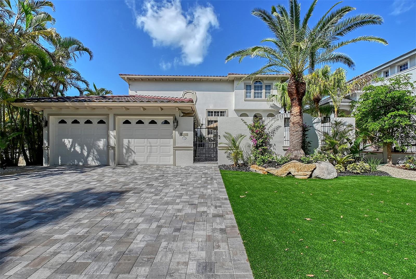 Welcome to one of the most desirable streets on Siesta Key, Roberts Point Road. Just steps from Shell Beach and minutes from the north bridge, this home blends island charm with thoughtful updates, including a brand-new roof in 2024. Enter through a tranquil, private courtyard, ideal for quiet mornings or intimate entertaining before stepping into a stunning interior with soaring 22' ceilings and grand windows that flood the space with natural light. The open floor plan is anchored by a beautifully designed kitchen featuring a large central island, high-end fixtures, and ample space for gathering. The main living area flows seamlessly to an outdoor patio and fenced, turfed space that is both low-maintenance and inviting. The spacious first-floor primary suite offers direct access to the courtyard balcony, dual walk-in closets, and a luxurious bathroom with adjacent laundry. Upstairs, guests will enjoy their own retreat with two flexible bonus areas. Perfect for a media loft and a dedicated office with built-ins, plus a second laundry room for added convenience. Live just a short bike ride from Siesta Key Beach, or head to Siesta Key Village, Southside Village, or downtown