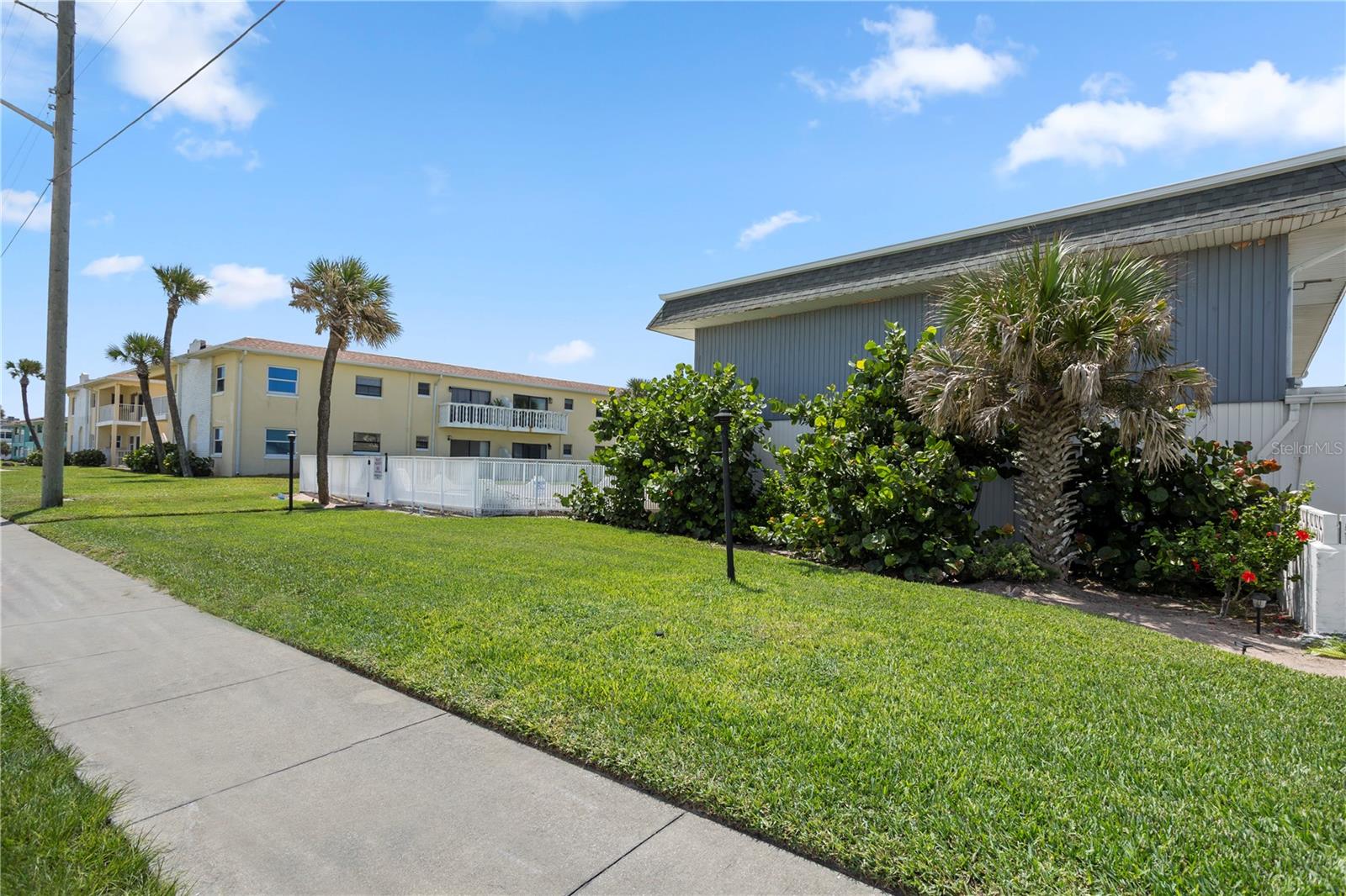 Step into coastal living at its best! Less than 150 feet to AIA and the beach, with nothing between your building and the beach and a nearby beach walkover, this beautifully updated home captures ocean views from both upstairs bedrooms. One bedroom offers a private balcony and large double closet, making it the perfect spot to wake up with the sunrise. Both baths have been updated. A full bath with a shower/tub combo serves the upstairs, while a second full bath with an upgraded shower is conveniently located downstairs. The custom kitchen is designed for entertaining with granite tiled countertops, stainless steel appliances, a tile backsplash, and an inviting eat-in bar. Tile floors flow through the downstairs for easy care, while the upstairs is finished with warm laminate flooring. A rare garage with attached driveway provides plenty of space for two to three cars, bikes, and beach gear, and hurricane-rated shutters on all windows and sliding doors and updated windows and sliders give added security and peace of mind. Offered fully furnishedincluding artwork, furniture, kitchenware, linens, and garage contentsthis home is truly move-in ready. Major updates include a new roof (2022), A/C condenser (2023), and air handler (2018) new garage door and opener (2025). Whether you're looking for a full-time residence, a vacation getaway, or an investment, this ocean-view home delivers the perfect blend of comfort, convenience, and beachside lifestyle. Minimum 30 day rentals allowed; 2 pets under 25 lbs allowed. By appointment only; call today!