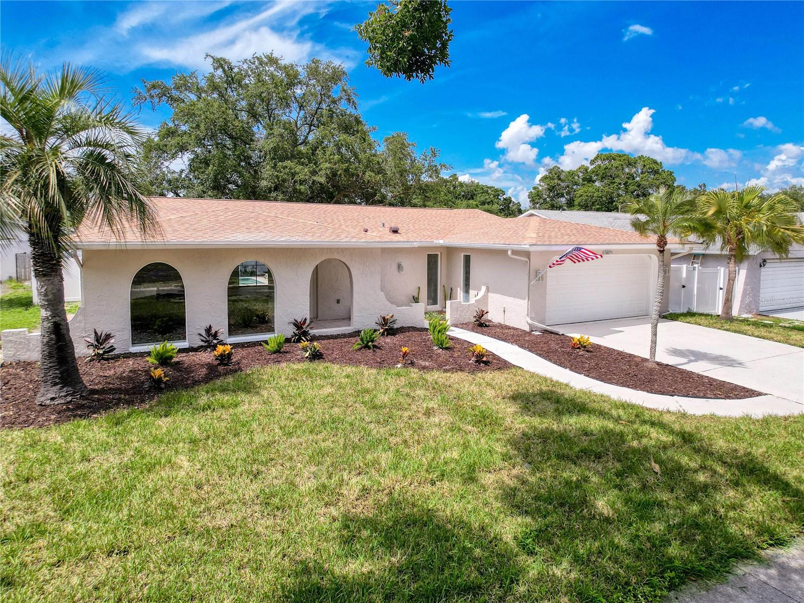 Welcome to your Tarpon Springs retreat! This beautifully updated 3-bedroom, 2-bathroom pool home with a brand-new 2025 roof offers over 2,250 sq. ft. of light-filled living space and an open floor plan. Step inside to find wood-look luxury vinyl flooring throughout, a dual-sided electric fireplace connecting the living and family rooms, and expansive windows showcasing gorgeous pool views from the kitchen, dining, and family areas. The kitchen is a chef’s delight with stainless steel appliances, granite countertops, and abundant cabinet storage. Both bathrooms have been stylishly updated with dual-sink vanities, new light fixtures, mirrors, and hardware. The spacious primary suite features direct access to the pool and a private spa-like bathroom with a walk-in glass-enclosed shower with a rain shower head, dual sink vanity, and a modern lighted mirror. Enjoy Florida living at its finest in your screened-in pool area-perfect for outdoor dining, grilling, or lounging by the water. A private patio with a firepit, a fenced backyard, and updated landscaping add to the home’s appeal. Situated in a non-flood zone with no HOA, this home offers an unbeatable location near Tarpon Springs Golf Course, A.L. Anderson Park, Lake Tarpon, local restaurants, and zoned schools. Just a quick drive brings you to Gulf beaches and the historic Tarpon Springs Sponge Docks. This home truly combines style, comfort, and convenience. Schedule your showing today!