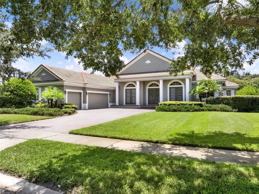 Tucked away in the prestigious guard-gated community of The Reserve at Lake Butler Sound, this exceptional 4-bedroom, 3.5-bath single-story pool home blends timeless Mediterranean style with modern sophistication. Set on over half an acre in a quiet cul-de-sac, the home welcomes you with a paver driveway, lush mature landscaping, and an elegant entry framed by architectural columns.
As you enter through the grand beveled glass French doors, you’re immediately greeted by soaring cathedral ceilings and sweeping views through the family room to the screened pool and spa beyond. The formal living and dining areas feature stately archways, tray ceilings, and designer lighting, creating a refined space for entertaining.
The heart of the home is the gourmet kitchen, designed with the chef in mind. Outfitted with granite countertops, a large breakfast bar, and a sunny dinette space, it flows effortlessly into the family room where a natural gas fireplace and rich wood floors add warmth and charm.
The spacious Owners Suite is tucked away for privacy, offering a tranquil retreat with travertine flooring, dual walk-in closets, a luxurious ensuite bath with double vanities, a large walk-in shower with dual heads, and a built-in wet bar. A flexible sitting area just outside the suite can serve as a home office, reading nook, or nursery.
Bedrooms two, three, and four offer generous space and privacy, including a jack-and-jill bath and an additional full hallway bath. A dedicated office near the front of the home can easily serve as a fifth bedroom if needed. Additional highlights include a powder room, oversized laundry room, and a 3-car courtyard-style garage.
Unwind on the ceramic-tiled pool deck surrounded by tranquil landscaping and dramatic lighting, offering a peaceful backdrop for evenings outdoors. Residents enjoy exclusive access to a community fishing pier on Lake Butler and a charming garden park, all just minutes from top-rated public and private schools, downtown Windermere, major roadways, Disney, and upscale shopping and dining.