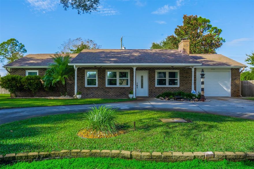Beautiful brick front home in the Florida Shores! Stunning curb appeal and circular driveway with coy pond is what you will find upon your arrival at this 1,410 sq. ft. one car garage home. This 3BR/2BA home has a kitchen with breakfast bar and a large living/dining area with a wood burning fireplace. Bedrooms with ceiling fans. New windows installed in 2020, and exterior paint 2018. Relax on your shaded front porch or your large screened lanai with jacuzzi! Cool off in your private pool while overlooking the beautifully landscaped, fenced backyard! A great backyard for entertaining family and friends! Irrigation system runs off the well. This home has so much to offer and many possibilities! Only 8 miles to New Smyrna Beach and shops, and only 4 miles to I95. ;Water: City