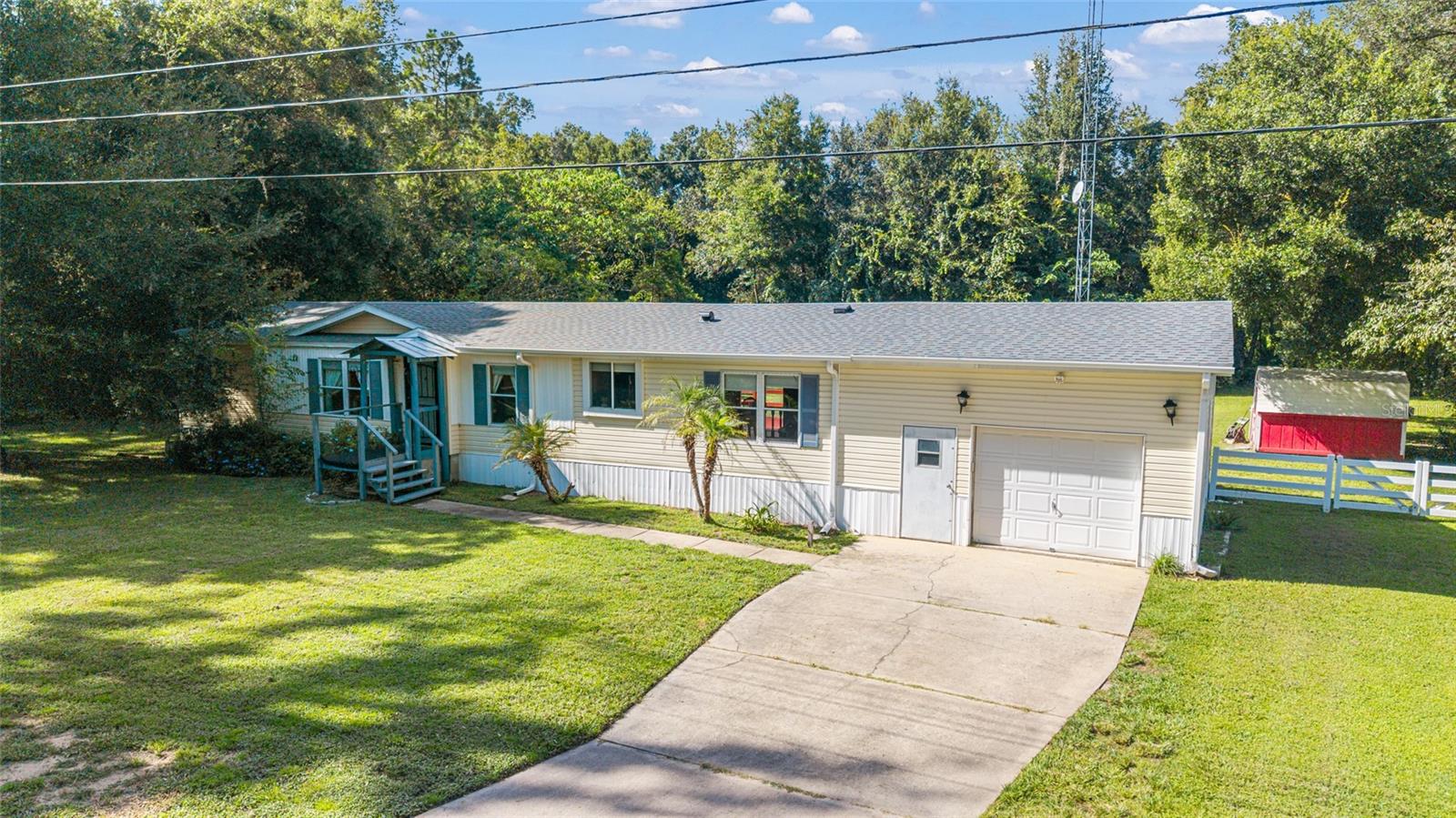 Your Own Slice of Country Paradise
Welcome to a home that offers the space, comfort, and beauty you've been dreaming of—a place where every corner feels like your own personal retreat. This spacious 3-bedroom, 2-bath manufactured home sits proudly on ¾ of an acre of peaceful, tree-lined land, offering the perfect blend of privacy and convenience.
Inside, you'll find two generous living areas, giving you room to relax, entertain, or spread out with loved ones. A cozy fireplace adds warmth and charm, while the dining area and bright eat-in kitchen make gathering a joy. The large primary suite is your own personal hideaway, complete with a private bathroom featuring a soaking garden tub—perfect for unwinding at the end of a long day.
Step outside to your fenced backyard oasis—a stunning space filled with fruit trees, open sky, and a beautiful back deck made for slow mornings, summer cookouts, or stargazing nights. There’s even a detached one-car garage with a concrete floor and plenty of storage, plus an additional shed to keep things organized.
Surrounded by majestic shade trees and horse farms, the setting is peaceful and private, yet just 25 minutes to both Ocala and Gainesville. Whether you're headed to WEC, HITS, or just into town, you’re perfectly positioned for it all and just 25 minutes!!
With a brand new roof installed in 2025, this move-in-ready home is priced to sell.