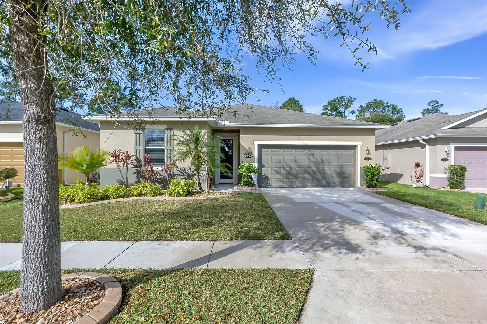 Check out this light, bright and ready to move in family home at the Isles of Sugar Mill! Very open floor plan with modern kitchen with wood cabinets and back splash, breakfast bar, spacious island and pantry. Open living area and dining room with a sliding glass door leading to the spacious screened lanai with cable. Private Master Suite with walk-in closet with custom designed Top Drawer shelving, double sinks, tiled shower and built-in desk. Two additional bedrooms in a split bedroom plan share the 2nd bath with tub and shower. Beautiful bamboo flooring, inside laundry and extra storage. Fully fenced yard with gate, new exterior paint, aluminum hurricane shutters. Community pool, children's playground and walking trails. A great home for a great price! All measurements approximate. ;Water: City