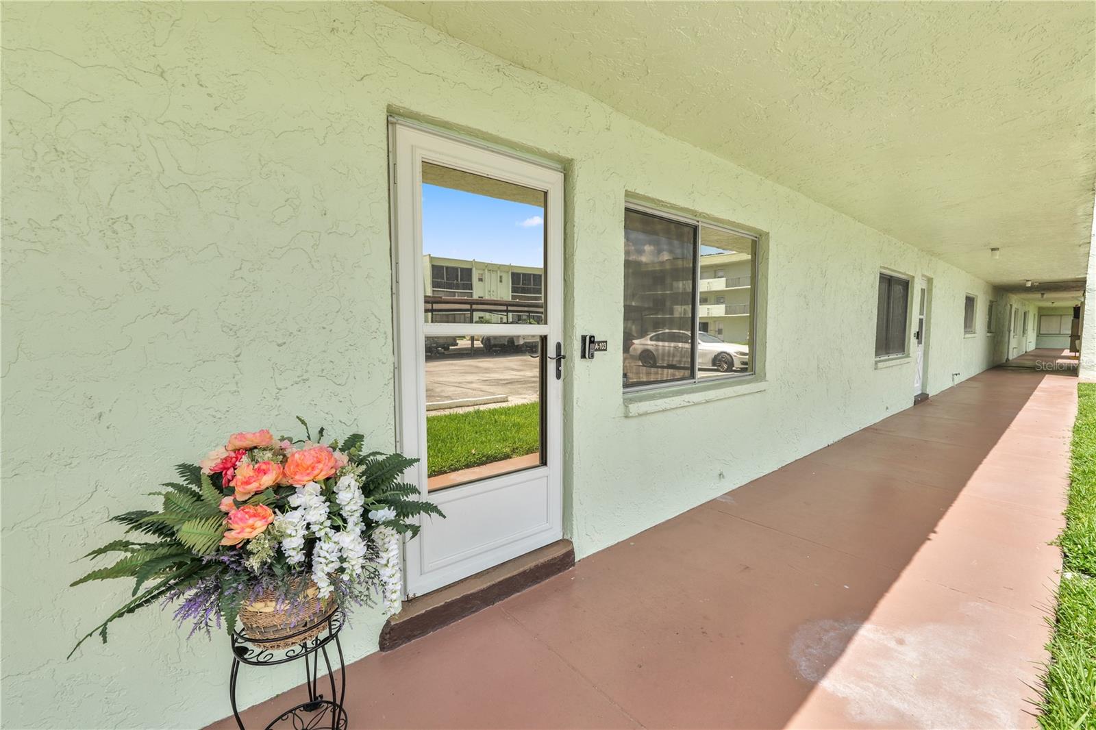 Welcome to your beautiful 55+ unit featuring 2 bedrooms, 2 bathrooms 1st floor condo overlooking the beautiful shores of Lake Parker with easy access to shopping, dining, and major roadways! Walk out your back door to your lakefront with beautiful sunsets. This gem has been lovingly cared for and includes a NEW AC in 2023, remodeled kitchen and bathrooms, new flooring throughout and a whole home security system in 2022, new privacy shades in the Florida room in 2020, all windows are tinted for energy efficiency and a new water heater in 2018. Entering the home you’ll love the new LVP flooring throughout and the bright and open living space. The living room flows seamlessly into the dining area, the perfect spot for entertaining friends and family. The stunning kitchen features granite countertops, stainless steel appliances, a breakfast bar, and a closet pantry for storage. You’ll also find the indoor laundry room just off the kitchen with extra storage space. The primary bedroom offers generous space, with 2 walk in closets! The en-suite provides a single sink granite topped vanity, along with a tiled stand up shower with shower seat and glass doors. The second bedroom offers plenty of space and natural lighting. The remaining bathroom has a granite topped vanity, and a tub/shower combo with tile surround. This home also has an all seasons Florida room equipped with tinted windows, keeping the home cool and privacy shades. The outdoor patio is the perfect spot to watch the Florida sunsets over Lake Parker and enjoy the lush greenery. The home also has an audio/video recording security system. Additionally, the home has 3 designated parking spots, 2 uncovered and 1 covered. The HOA covers your internet, cable, land line, water, sewage, outside pest control, lawn maintenance, and dumpster for trash disposal. The amenities include the community pool, tennis courts, dog park, shuffleboard, and access to the clubhouse, and fishing pier. This property has so much to offer! Schedule your private showing today!