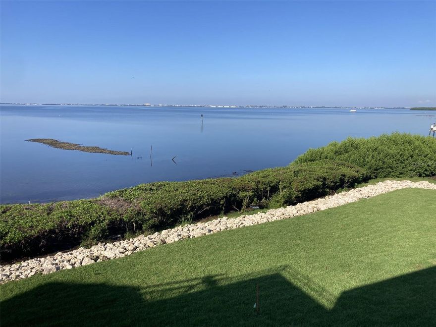 Must see! A million dollar view for half the price! Appraised March, 2025 for $560,000.  Absolutely beautiful panoramic view of Sarasota Bay from this spacious two bedroom - two bath condo in Wild Oak Bay.  There is high gloss tile throughout plus the kitchen has been updated with Kitchen Maid cabinets, granite countertops, stainless steel appliances and attractive back splash plus tray ceiling with recessed lighting and ceiling fan.  The master bathroom shower has newer tile and sliding doors - master bedroom has a walk-in closet plus another set of closets and most importantly sliding doors to lanai with a view of the bay. Also recently installed are all new hurricane proof double paned windows and sliders.  The lanai also has tile floors and a closet which can be used for storage or a small office.  There are new blinds on the lanai which are controlled by a wall mounted remote control.  There is an open patio in front - perfect for plants and seating.  The condo is directly across from the elevator.  There is a carport plus guest parking. New roof in 2025.  New drainage system in back yard to counteract future storms. Owner has paid all assessments to date.  Owner ready to negotiate. The condo is located in the IMG Country Club area, which features an 18 hole regulation size semi-private golf course and a clubhouse/grill room overlooking Sarasota Bay.  There is also a tennis club in the area.  Located near schools, shopping, grocery stores and minutes away from the airport and Sarasota.  Approximately 8 miles to the beach.  This is an all age condo and allows two large pets.