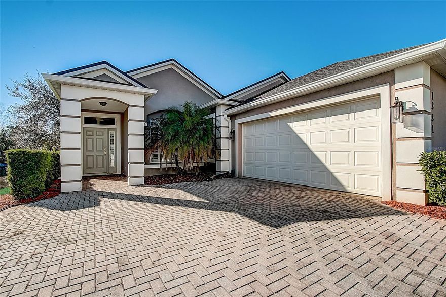 Light and bright in LPGA with a BRAND NEW ROOF! Fall in love with the Florida lifestyle with the wrap-around screened lanai providing sparkling water and wildlife views. Guests are greeted with a pavered driveway and gorgeous architectural columns and double tray ceilings upon entry. Plantation shutters are featured throughout the home. The kitchen is equipped with granite countertops, bar seating, and ample storage and cabinet space. The primary suite is spacious with double vanity sinks and has access to the screened lanai. Laundry room includes a utility tub and natural lighting! LPGA International is a semi-private golf club offering two championship golf courses, sports bar and grill, pool, and fitness center. Membership is optional and not included in HOA fees. Ideal location close to the new Publix Shopping Center at Latitudes, Tanger Outlets, and Tomoka Town Center. ;Water: City
