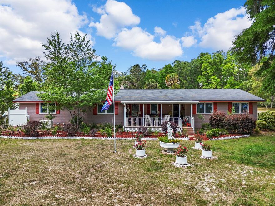 Nestled in the heart of beautiful Columbia County, this stunning property offers the perfect blend of comfort, style, and natural beauty. Just minutes from the crystal-clear Ichetucknee Springs, an A-rated charter school, shopping, and restaurants, you’ll enjoy both convenience and serenity.

Set on a spacious, fully fenced corner lot with an electric gate, this home was designed for both relaxation and functionality. Featuring 4 bedrooms and 4 bathrooms, a mother-in-law suite, and two kitchenettes, it provides plenty of room for family, guests, or multigenerational living.

Outdoors, you’ll find endless opportunities to unwind or entertain. Take a dip in the huge Olympic-size screened-in pool, enjoy coffee on the expansive front porch, or relax on the side and back porches while watching the breathtaking sunsets and local wildlife beneath the shade of majestic oak trees. The property also includes a carport and garage, plus an RV hookup and a pool house with a shower for added convenience.

Inside, the home features upgraded appliances, modern bathrooms, and new flooring throughout. Elegant touches like the beautiful wood-burning fireplace, custom ceiling designs, and sophisticated wall décor make every space feel warm and inviting.

Come experience the perfect mix of style, tranquility, and functionality — this private country retreat truly has it all!