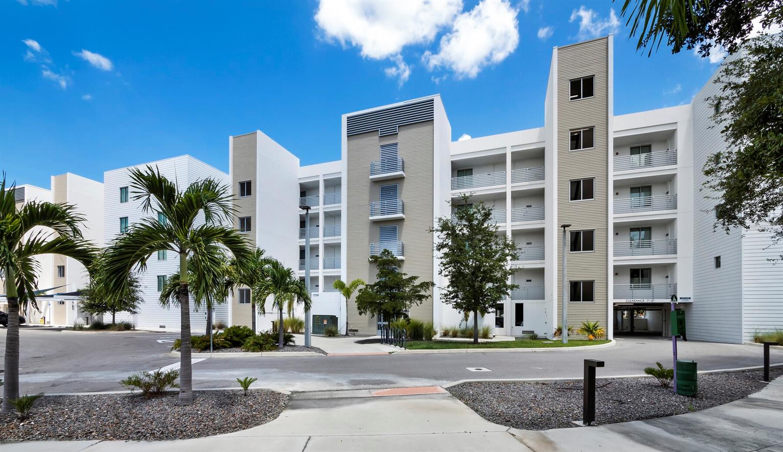 Experience waterfront luxury at The Strand of Sarasota. Rarely lived in and never rented, this Penthouse, newer (2022) turnkey-furnished home includes a deeded boat slip with a 10,000 pound Neptune lift with connected water and electricity, a fully equipped 2023 Scout 177 Sport flats fishing boat, and a kayak for one price. Direct boating access to Sarasota Bay and the Gulf of Mexico. Located on the fifth floor, the residence features two full bathrooms and a versatile den with barn doors, complete with a custom wall bed and California Closets built-ins easily utilized as a second bedroom. Unmatched upgrades throughout include luxury vinyl plank flooring, glossy cabinetry, quartz countertops, kitchen tile backsplash, Samsung appliances, flat-screen TV, and designer light fixtures from Herman Miller and West Elm. Nine-foot impact rated sliding glass doors fill the great room with natural light and open to a private terrace with stunning sunset views of the canal and Sarasota Bay. A floor-to-ceiling vertical cellular shade provides privacy when needed. The primary bedroom includes a spacious walk-in closet with custom built-ins by California Closets. The boat lift, installed using 10" diameter wrapped pilings punched 10 feet deep and warrantied by Duncan Seawall, Dock and Boat Lift, ensures lasting quality and peace of mind. Residents of The Strand enjoy resort-style amenities including a heated swimming pool and spa, fitness center, gas fire pit and grills, EV charging stations, dog park, and kayak launch with storage. Just minutes from Sarasota vibrant arts, culture, dining, and the new bayfront entertainment area, The Strand offers an ideal setting for a full-time residence, vacation getaway, or investment property, with weekly rentals permitted.