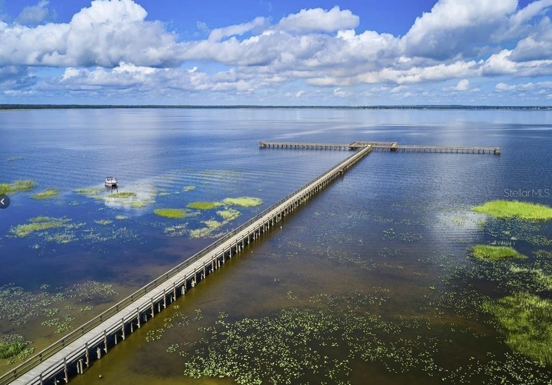 Prime Half-Acre Lot – Perfect for Nature Lover’s Paradise with Resort-Style Amenities! Discover the perfect blend of peace, recreation, and convenience in this beautiful half-acre lot —a gated lakefront community in the heart of Florida. This sought-after community is built around the 7,500-acre Lake Walk-In-Water, renowned for some of the best bass fishing in Florida. Residents enjoy exclusive access to a private beach, boat ramp, marina, and Florida’s longest freshwater fishing pier, complete with a lakeside pavilion, propane grills, and covered picnic areas—perfect for family outings. Is a haven for outdoor enthusiasts with amenities that include: An 18-hole golf course Basketball and tennis courts A 23,000 sq. ft. clubhouse with a café, fitness center, library, and pro shop On-site post office, churches, and walking/biking paths Embrace the natural beauty around you—wildlife sightings are a daily delight with deer, cranes, turkeys, turtles, and more roaming the area. Ideally located just 20 miles east of Lake Wales, you're also only about an hour from Orlando and Disney, and a little over an hour from Tampa and the Gulf Coast beaches. Whether you're building your dream home or investing in your future, this lot offers the best of Florida living—tranquility, community, and adventure all in one place.