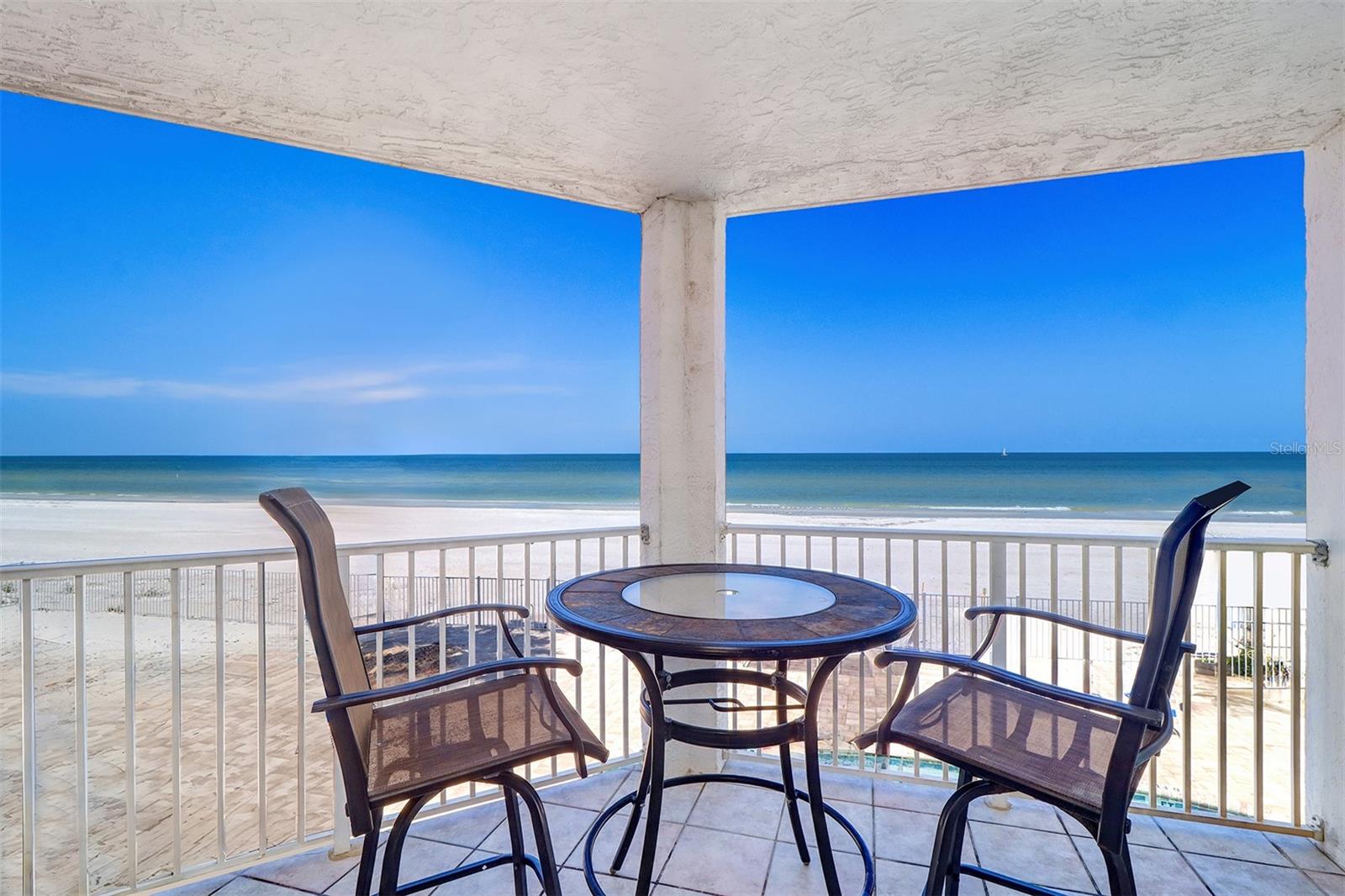 Weekly rentals permitted, strong rental history! Direct beach front spacious two-bedroom, two-bath 1,380-square-foot condominium with superb views of the blue tropical waters and white sandy beaches of the Gulf of Mexico and the Intracoastal Waterways. There are gorgeous water views from just about everywhere you are in this beautiful open floor plan condominium! The large gulf-front balcony has a stairwell that takes you directly to the beach and pool. In addition, a private balcony on the east side with views of the Intracoastal where you can have coffee and watch the beautiful sunrises, and keep an eye on your boat at the dock. You can also ride the semi-private elevator at your foyer door down to the beach, pool and a private dock on the Intracoastal. This unit comes with an under-building assigned parking space and private storage closet in the foyer outside the front entry door. During pre-construction, this floor plan also had the ability to be constructed as a third bedroom. Therefore, this unit could be converted to a third bedroom. This location in Indian Rocks Beach is called The Narrows, one of the unique locations in all of the Pinellas County beaches, providing access and views to the Gulf of Mexico and Intracoastal Waterway. Bring your island attitude to this special place! In addition to the white sand beach front condo, the private waterfront dock awaits on the Intracoastal for fishing and boating. Choose your view of magnificent sunsets from the large open living room, dining, kitchen, balcony or beach. Watch the morning sunlit sky over the Intracoastal from your private balcony. This unit comes fully furnished and decorated, and solid roster of potential future rental bookings. Resort-style amenities include heated pool, patio, barbecue grill, private dock and assigned parking. Activities include 10 restaurants within a 10-12-minute distance or five-minute drive. Paddleboard, kayak and boat rentals are nearby. Splash Harbor Water Park is a three-minute ride. The Sun Coast Beach Trolley stops in front of the condominium daily, and can safely and conveniently take you to all the hot spots along the 26-mile stretch of Pinellas County beaches from Clearwater Beach all the way down to St. Pete Beach. Make your appointment now, you won't be disappointed.