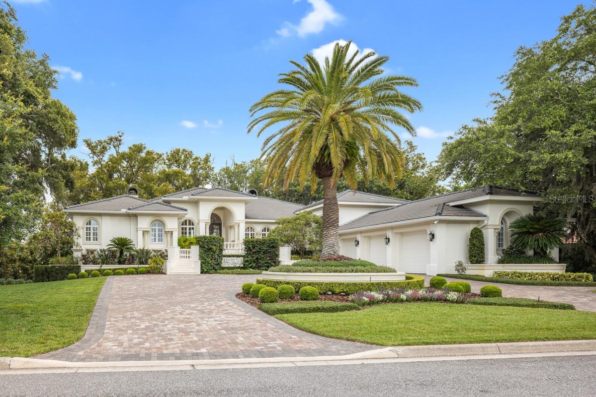 From the moment you enter this exquisite estate, you are embraced with an open and breathtaking view of Lake Isleworth. Nestled between the lake and Isleworth Country Club’s driving range, the home boasts just over 6,500 sqft with 4 bedrooms, 4 full baths and a powder bath. The newly renovated modern kitchen with state-of-the-art appliances welcomes you with an entertainment space, wine refrigerator and majestic lake views. The elevator conveniently located by the kitchen and the garage, make it accessible to bring your groceries up. The garage includes golf cart parking, a charging station and a lift for an additional car. As you make your way downstairs to the open bonus room, 3 ensuites accommodate family and guests with access to the lakeside oasis with a spa and retractable screens around the large porch area. A few steps away through the garden along a brick path is the enchanting beach shore and boat dock awaiting for you to enjoy the serene sunset views.