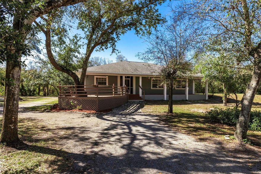 $20,000 Seller Concession Offered to Buyer at Closing with Full-Price Offer!  Serene 2.32-Acre Florida Retreat – No Flood Zone, No HOA, Prime Location!  Experience the perfect blend of privacy, space, and convenience in this beautiful 2.32-acre fully fenced property, ideally located in a peaceful rural community with paved roads—no dirt roads here—and no flood zone concerns. It’s the only acreage property this close to town, offering a rare combination of country living and urban convenience. A NEW ROOF (2020) and whole-house re-plumbing provide lasting value and peace of mind.  A picturesque winding driveway framed by mature oak trees welcomes you to this tranquil retreat. The shaded property naturally keeps the home cool, enhancing comfort and energy efficiency year-round. Despite its private, secluded feel, you’re just minutes from shopping, dining, and the charming downtown district along the Peace River. With quick access to I-75, you can easily reach Sarasota to the north and Fort Myers to the south, making this an ideal central location.  At the heart of the property stands a well-built 2,460 sq. ft. elevated Key West–style home, offering 3 bedrooms and 2 bathrooms. The home features a welcoming front porch and sun deck—perfect for enjoying the peaceful surroundings. Inside, an open and spacious floor plan creates a warm, inviting atmosphere highlighted by a fully functional dual-sided wood-burning stone fireplace that beautifully connects the great room and dining area. The home is move-in ready, with opportunity to add your own personal touches to make it truly your own.  Additional highlights include a 20x24 detached garage and a 10x12 storage building, offering ample room for vehicles, tools, and hobbies. And with no HOA, you’ll enjoy the freedom to use your property as you please—bring your RV, boat, or pets with no restrictions.  Whether you’re seeking a peaceful country retreat or a convenient home base close to town, this property offers the best of both worlds.  Don’t miss this rare opportunity—schedule your private showing today!