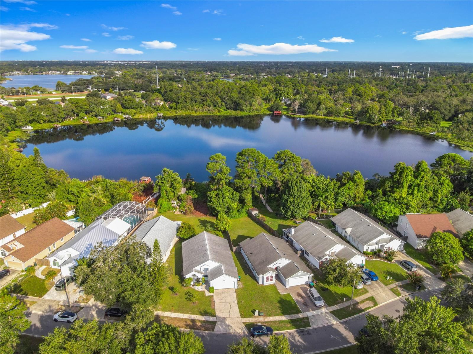 One or more photo(s) has been virtually staged. Welcome to 9355 Telfer Run—a rare LAKEFRONT opportunity in the heart of East Orlando with no HOA and endless potential. This spacious 4-bedroom, 2-bath home is nestled on a large waterfront lot and zoned for the highly regarded Winter Park High School, home to the International Baccalaureate program. With a new roof installed in 2020 and a flexible layout, the property offers excellent potential as a primary residence, rental investment, or private retreat. Just minutes from UCF, major roadways, shopping, and dining, the location offers both privacy and connectivity. The lush, oversized lot is adorned with several tropical fruit trees, creating a private backyard oasis perfect for relaxing or entertaining. Whether you're seeking a serene lakefront lifestyle or a smart investment , this property is a must-see.